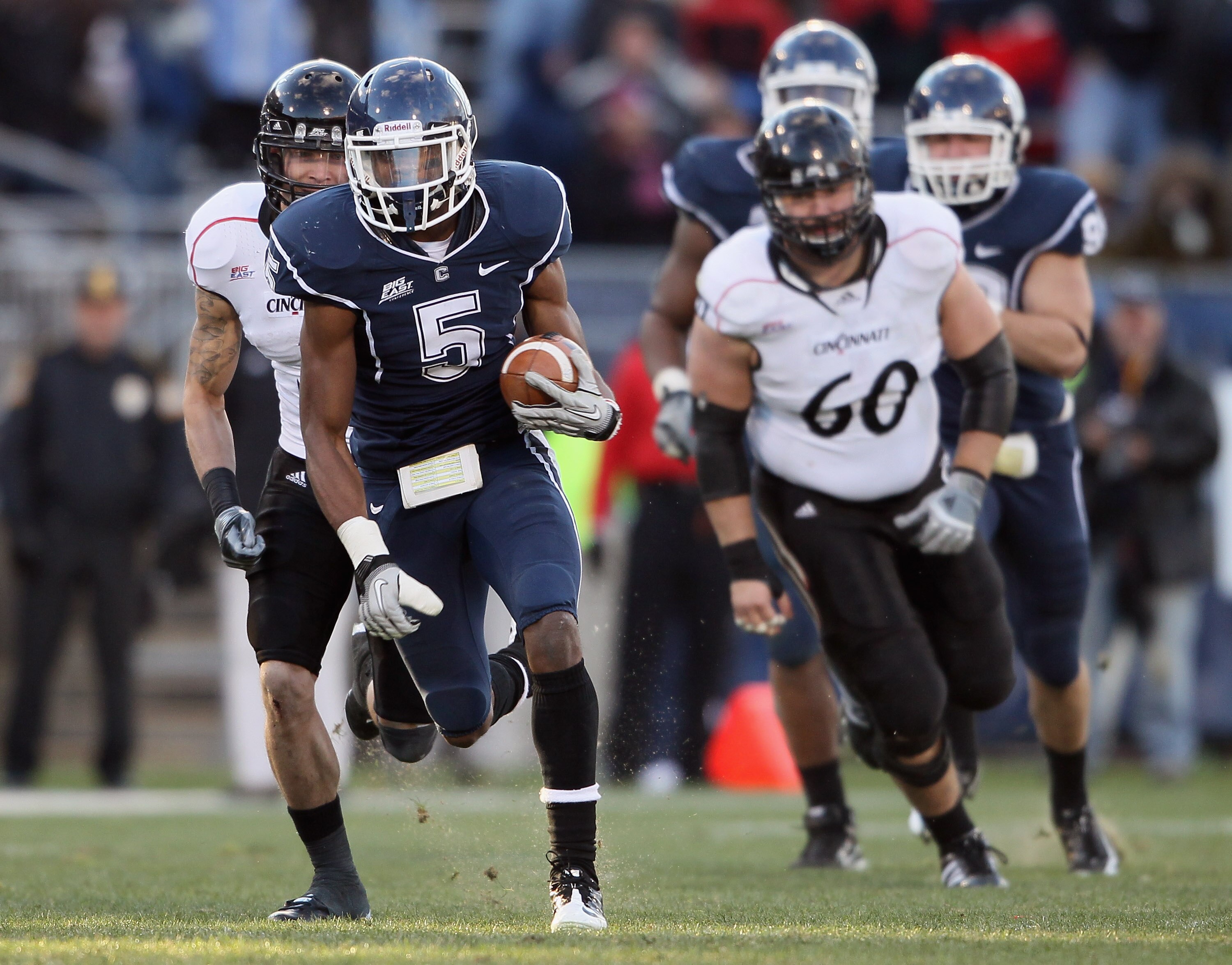 EAST HARTFORD, CT - NOVEMBER 27:  Blidi Wreh-Wilson#5 of the Connecticut Huskies avoids the Cincinnati Bearcats after he intercepted a pass in the fourth quarter on November 27, 2010 at Rentschler Field in East Hartford, Connecticut. The Huskies defeated
