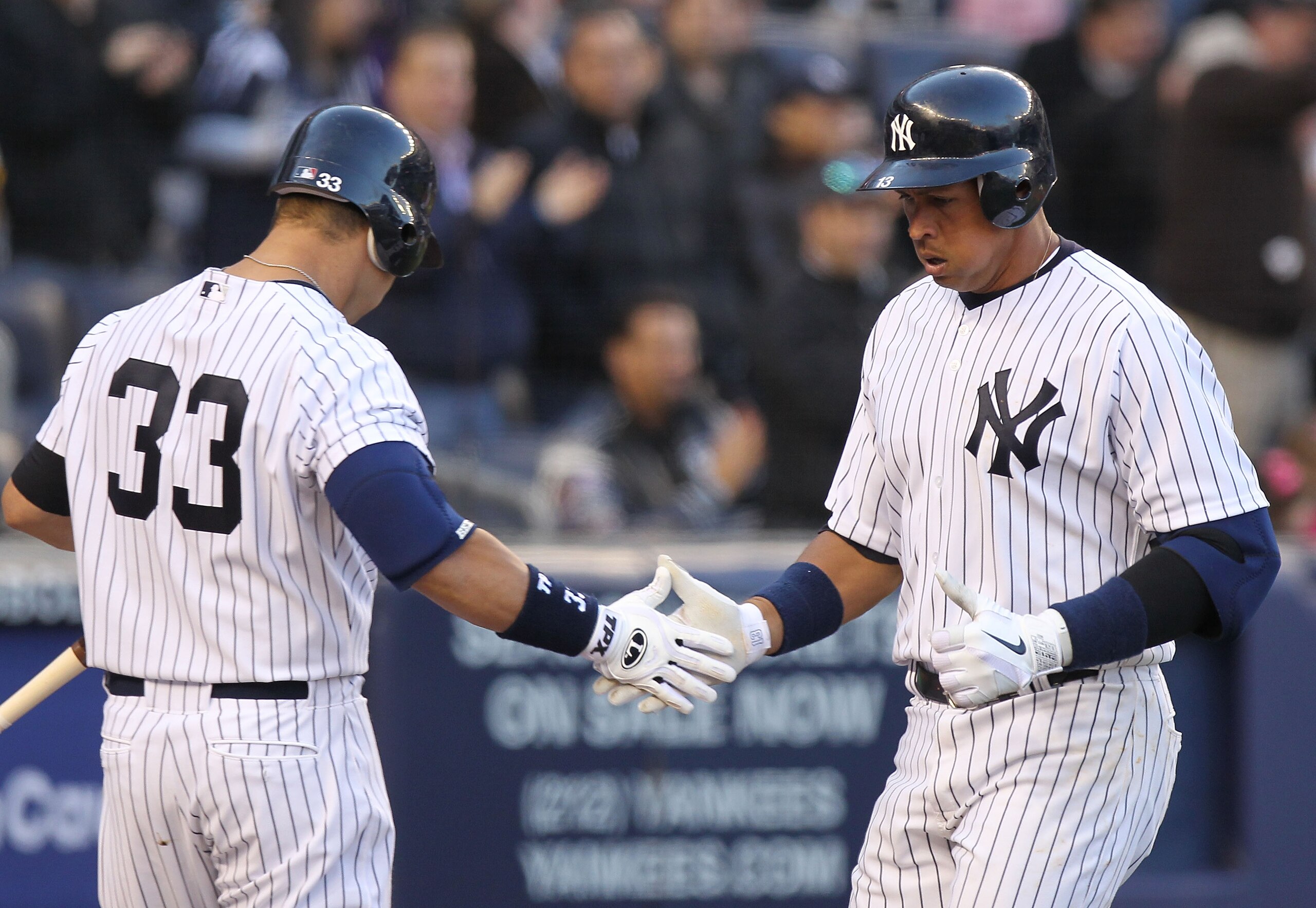 NEW YORK, NY - APRIL 02:  Alex Rodriguez #13 of the New York Yankees celebrates his solo homerun with teammate Nick Swisher #33 against the Detroit Tigers at Yankee Stadium on April 2, 2011 in the Bronx borough of New York City.  (Photo by Nick Laham/Gett