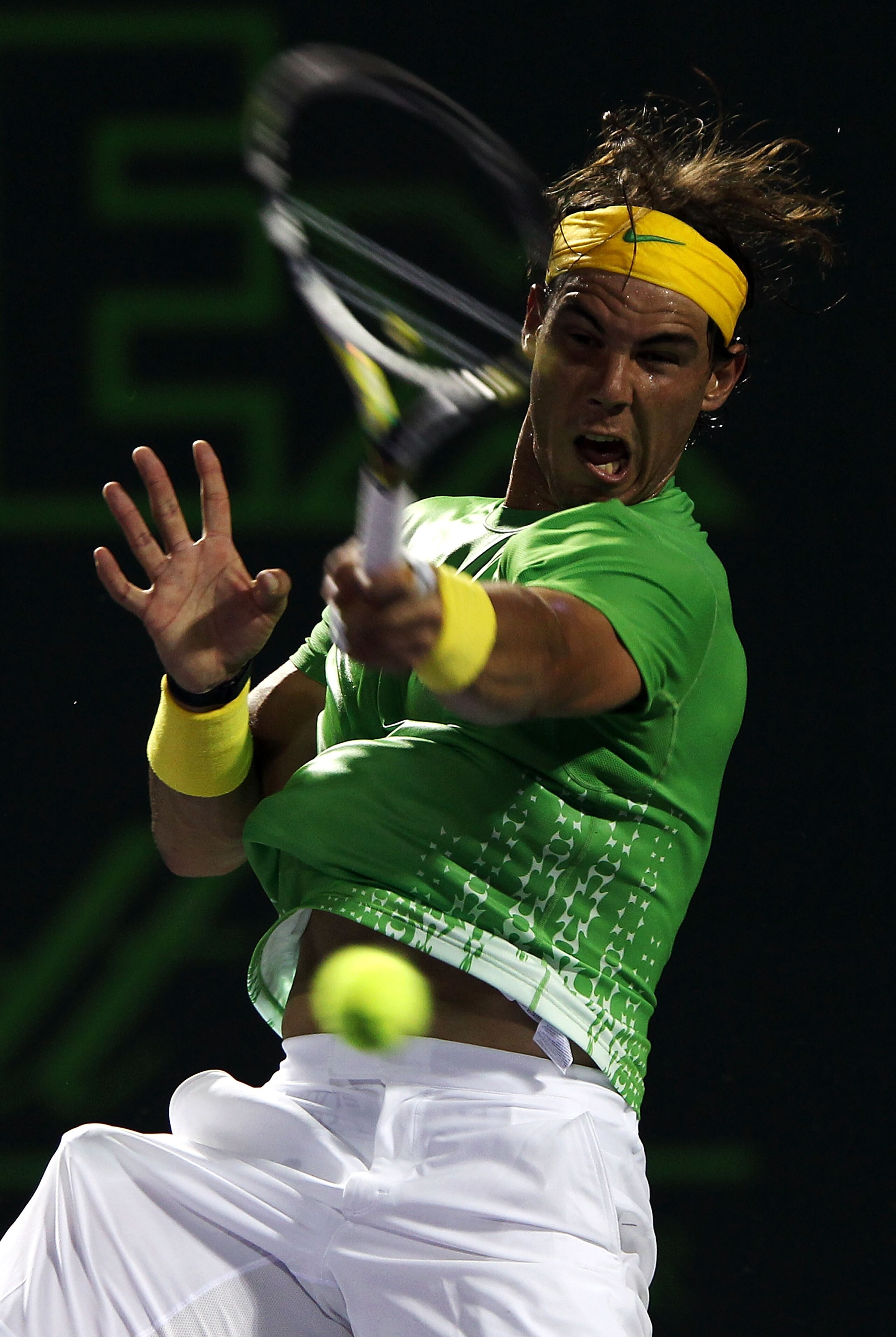 KEY BISCAYNE, FL - APRIL 01:  Rafael Nadal of Spain hits a forehand return against Roger Federer of Switzerland during their men's semifinal singles match at the Sony Ericsson Open at Crandon Park Tennis Center on April 1, 2011 in Key Biscayne, Florida.
