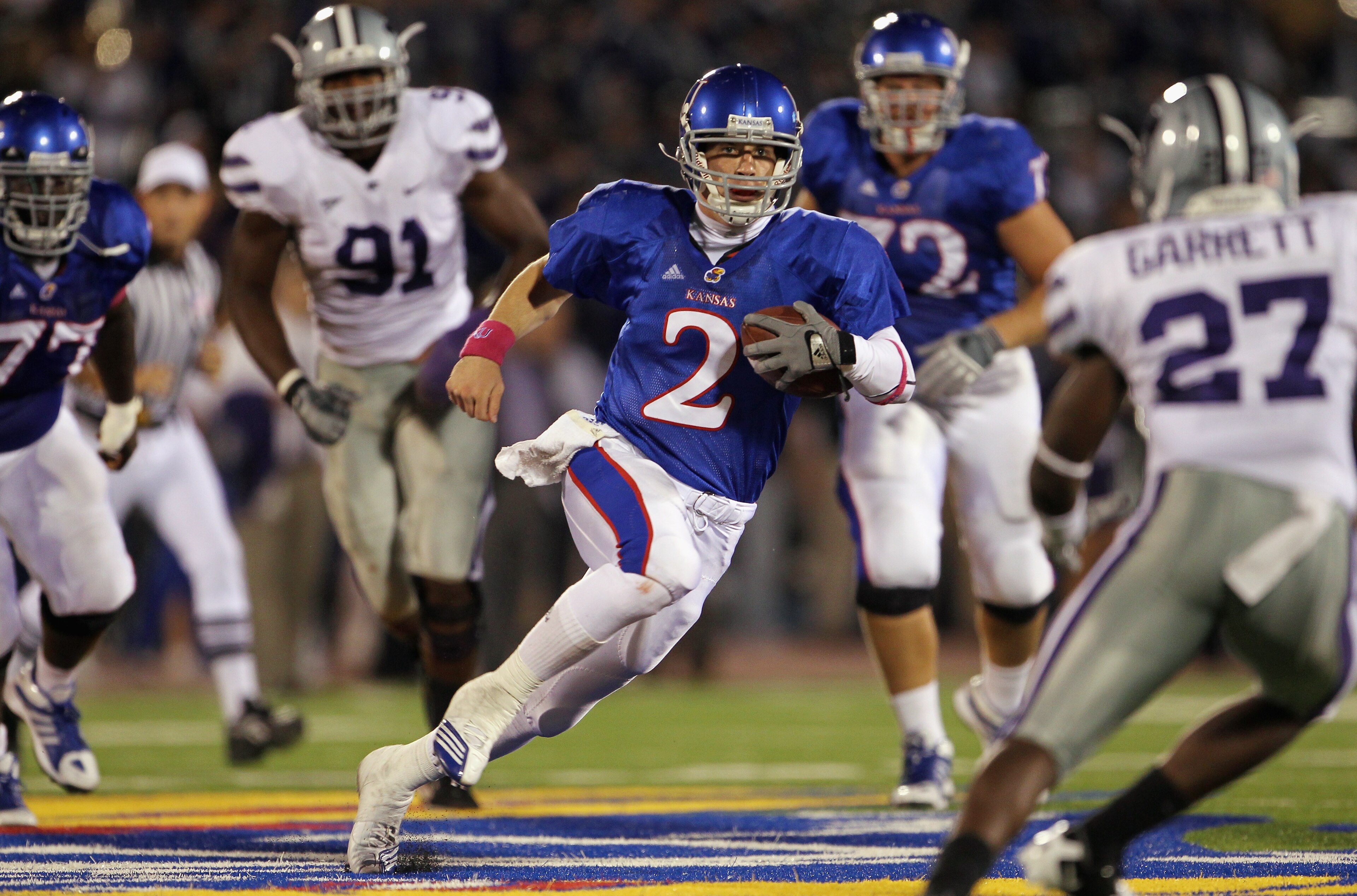 LAWRENCE, KS - OCTOBER 14:  Quarterback Jordan Webb #2 of the Kansas Jayhawks scrambles as David Garrett #27 of the Kansas State Wildcats defends during the game on October 14, 2010 at Memorial Stadium in Lawrence, Kansas.  (Photo by Jamie Squire/Getty Im