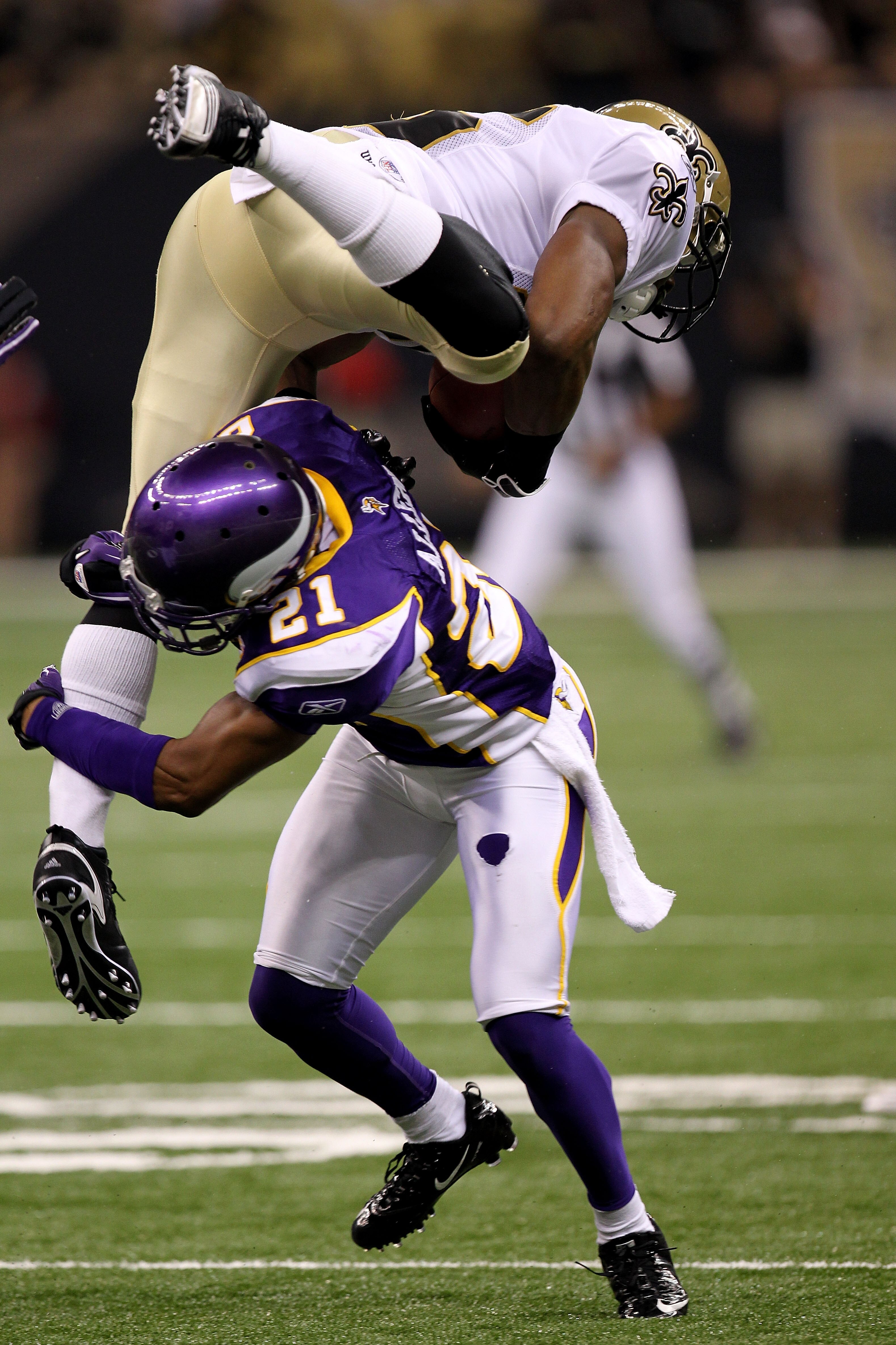 NEW ORLEANS - SEPTEMBER 09:  Reggie Bush #25 of the New Orleans Saints is tackled by Asher Allen #21 of the Minnesota Vikings at Louisiana Superdome on September 9, 2010 in New Orleans, Louisiana.  (Photo by Ronald Martinez/Getty Images)