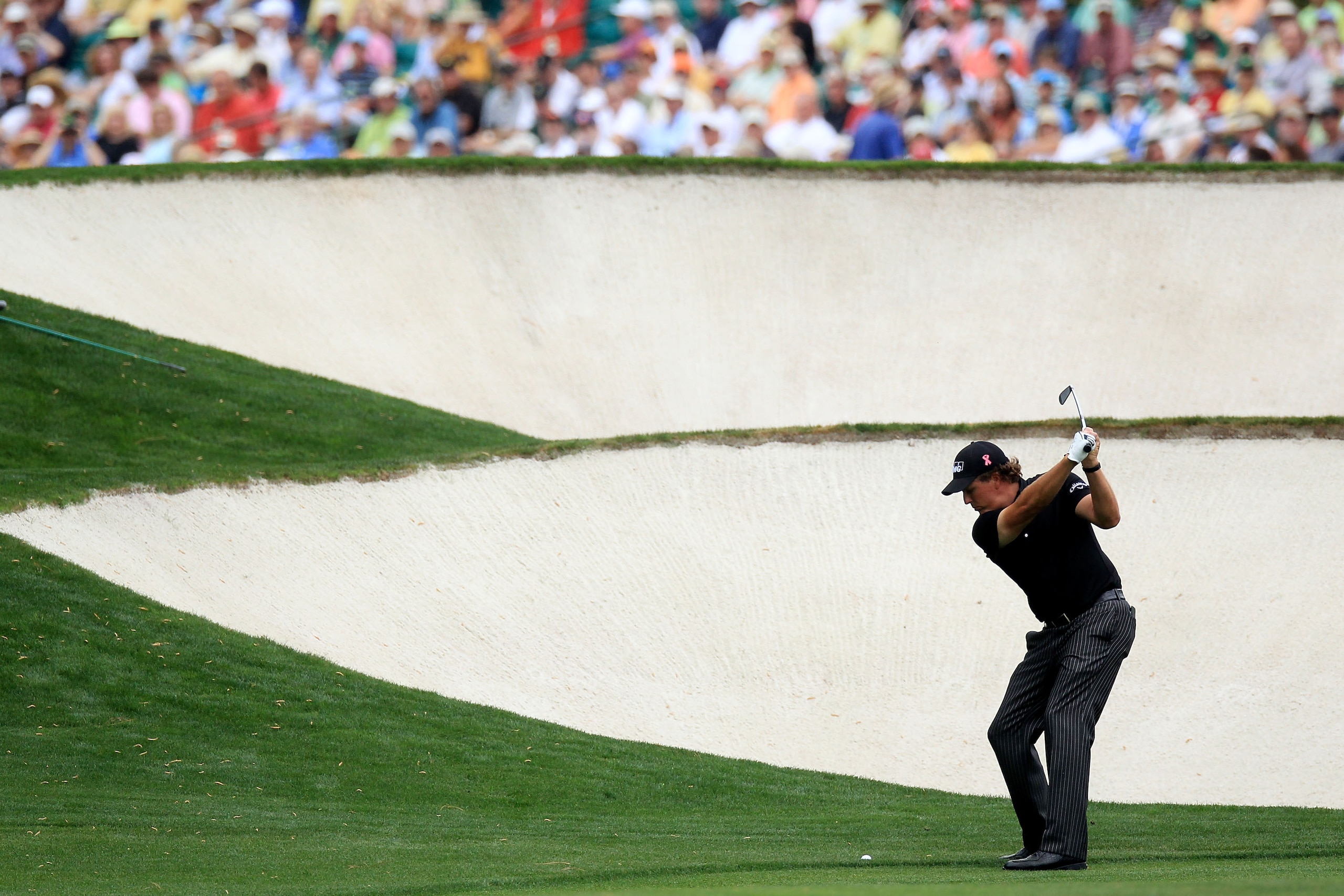 AUGUSTA, GA - APRIL 08:  Phil Mickelson hits his approach shot on the fifth hole during the first round of the 2010 Masters Tournament at Augusta National Golf Club on April 8, 2010 in Augusta, Georgia.  (Photo by David Cannon/Getty Images)