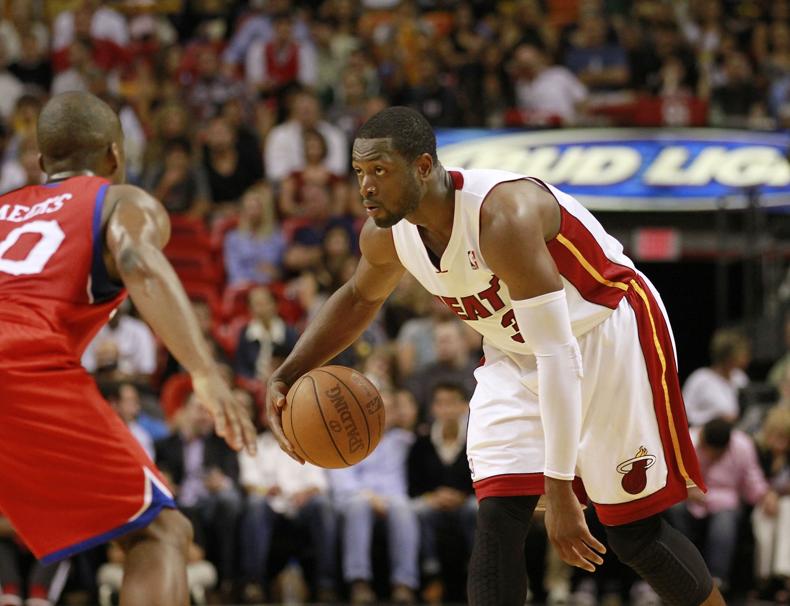 MIAMI, FL - MARCH 25: Guard Dwyane Wade #3 of the Miami Heat drives against Guard Jodie Meeks #20 of the Philadelphia 76ers at American Airlines Arena on March 25, 2011 in Miami, Florida. The Heat defeated the Sixers 111-99. NOTE TO USER: User expressly MIAMI, FL - MARCH 25: Guard Dwyane Wade #3 of the Miami Heat drives against Guard Jodie Meeks #20 of the Philadelphia 76ers at American Airlines Arena on March 25, 2011 in Miami, Florida. The Heat defeated the Sixers 111-99. NOTE TO USER: User expressly