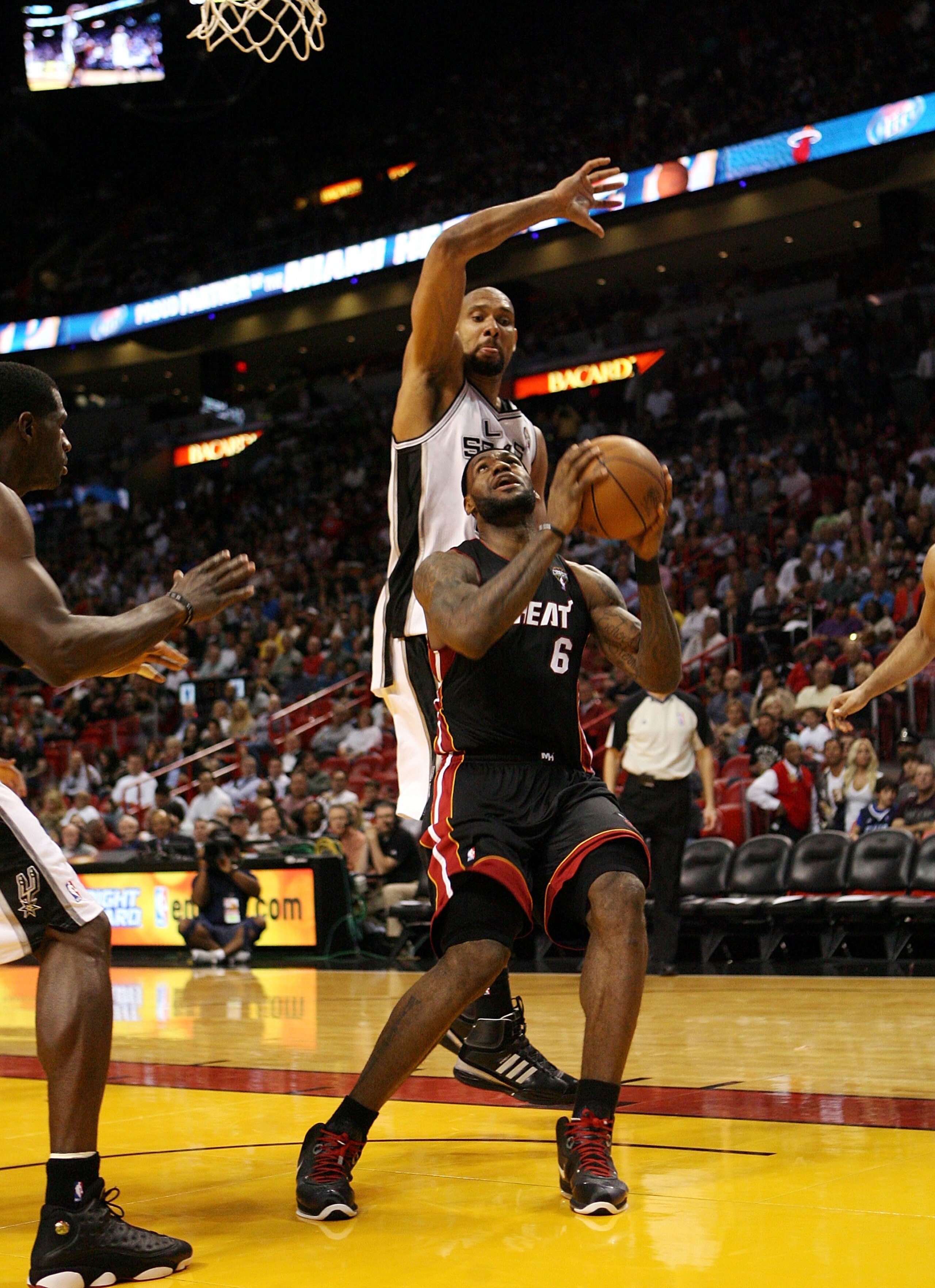 MIAMI - MARCH 14: Forward LeBron James #6 of the Miami Heat drives against Center Tim Duncan #21 of the San Antonio Spurs at American Airlines Arena on March 14, 2011 in Miami, Florida. The Heat defeated the Spurs 110-80. NOTE TO USER: User expressly ack MIAMI - MARCH 14: Forward LeBron James #6 of the Miami Heat drives against Center Tim Duncan #21 of the San Antonio Spurs at American Airlines Arena on March 14, 2011 in Miami, Florida. The Heat defeated the Spurs 110-80. NOTE TO USER: User expressly ack