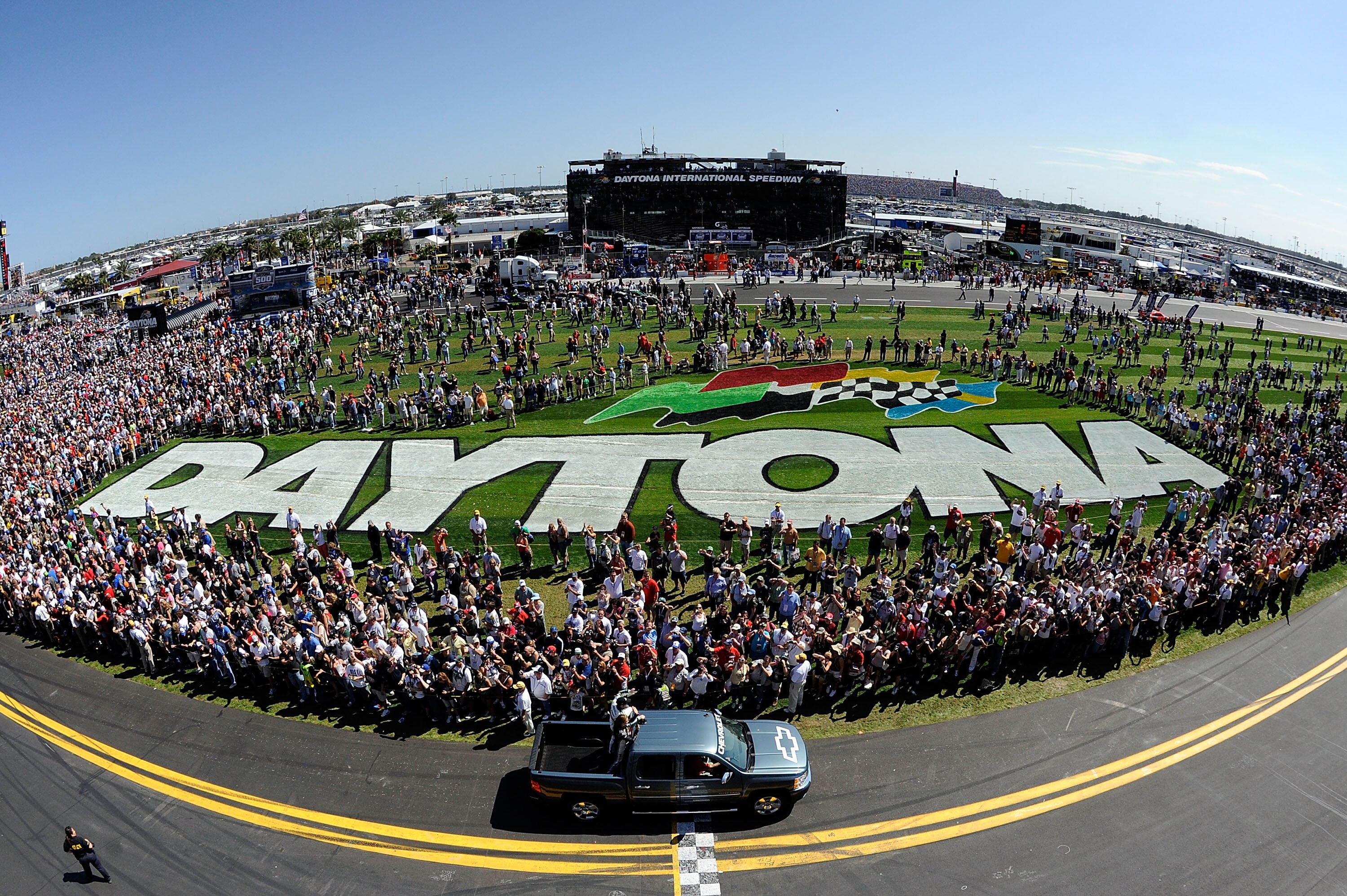 DAYTONA BEACH, FL - FEBRUARY 20:  Dale Earnhardt Jr., driver of the #88 National Guard/AMP Energy Chevrolet, rides past fans in a pickup truck during pre-race ceremonies for the NASCAR Sprint Cup Series Daytona 500 at Daytona International Speedway on Feb