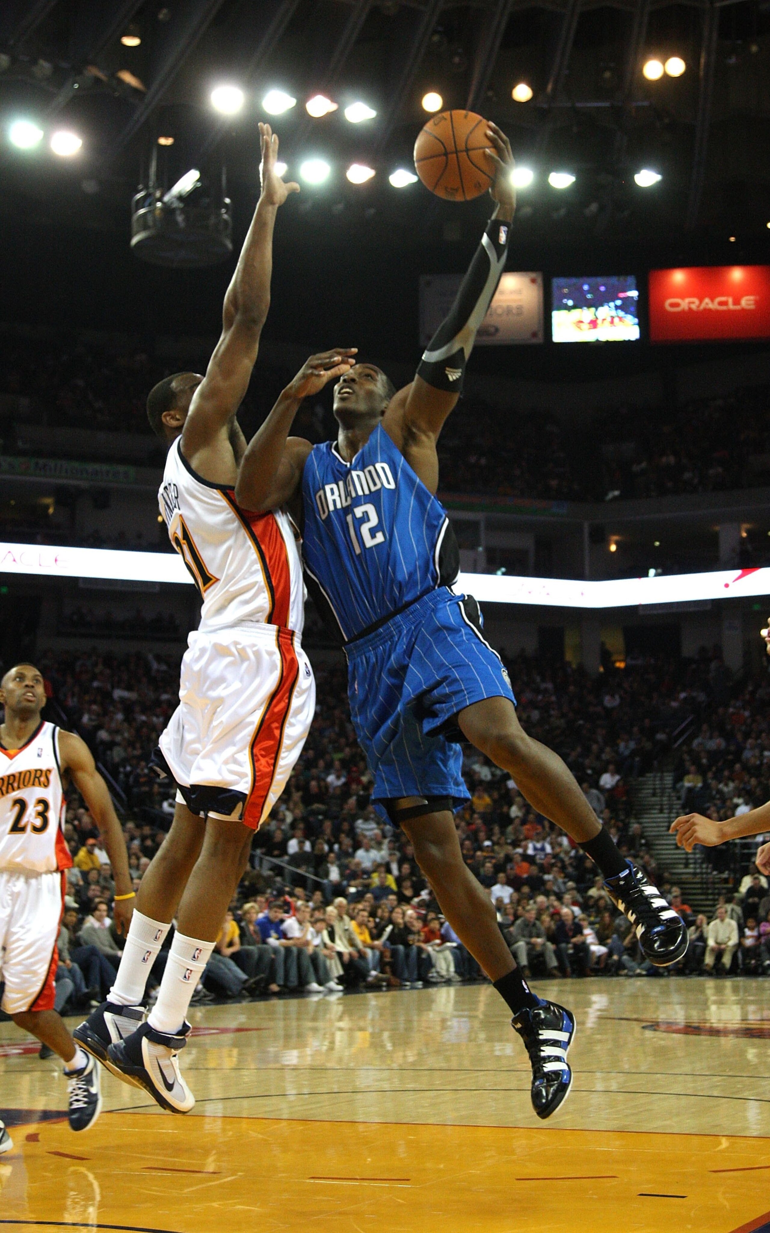 OAKLAND, CA - DECEMBER 05:  Dwight Howard #12 of the Orlando Magic in action against the Golden State Warriors during an NBA game at Oracle Arena on December 5, 2009 in Oakland, California. NOTE TO USER: User expressly acknowledges and agrees that, by dow