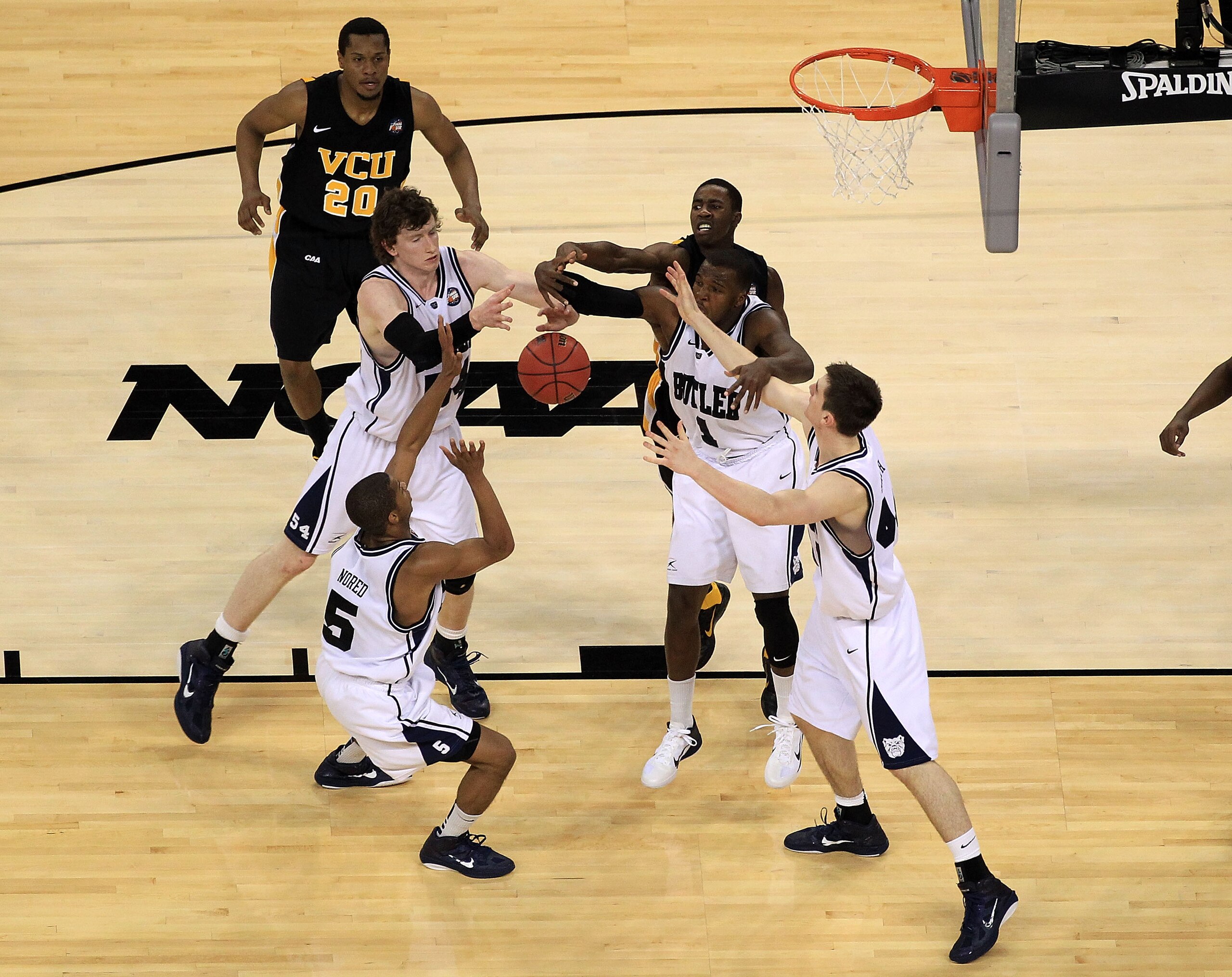 HOUSTON, TX - APRIL 02:  Rob Brandenberg #23 of the Virginia Commonwealth Rams fights for the ball against Ronald Nored #5, Andrew Smith #44, Matt Howard #54 and Shelvin Mack #1 of the Butler Bulldogs during the National Semifinal game of the 2011 NCAA Di
