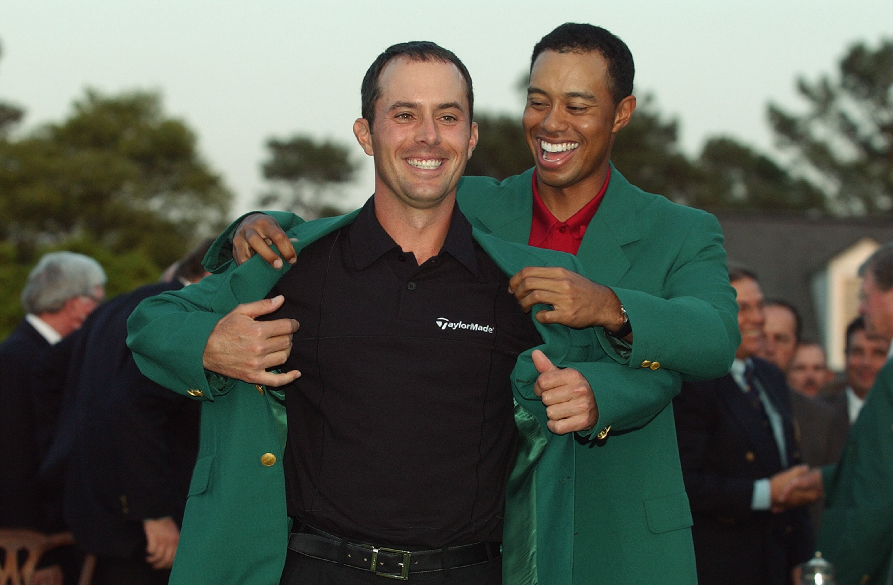 AUGUSTA, GA - APRIL 13:  Mike Weir of Canada is presented with the green jacket by Tiger Woods of the USA after winning the play off after the final round of the 2003 Masters Tournament at the Augusta National Golf Club in Augusta, Georgia on April 13, 20