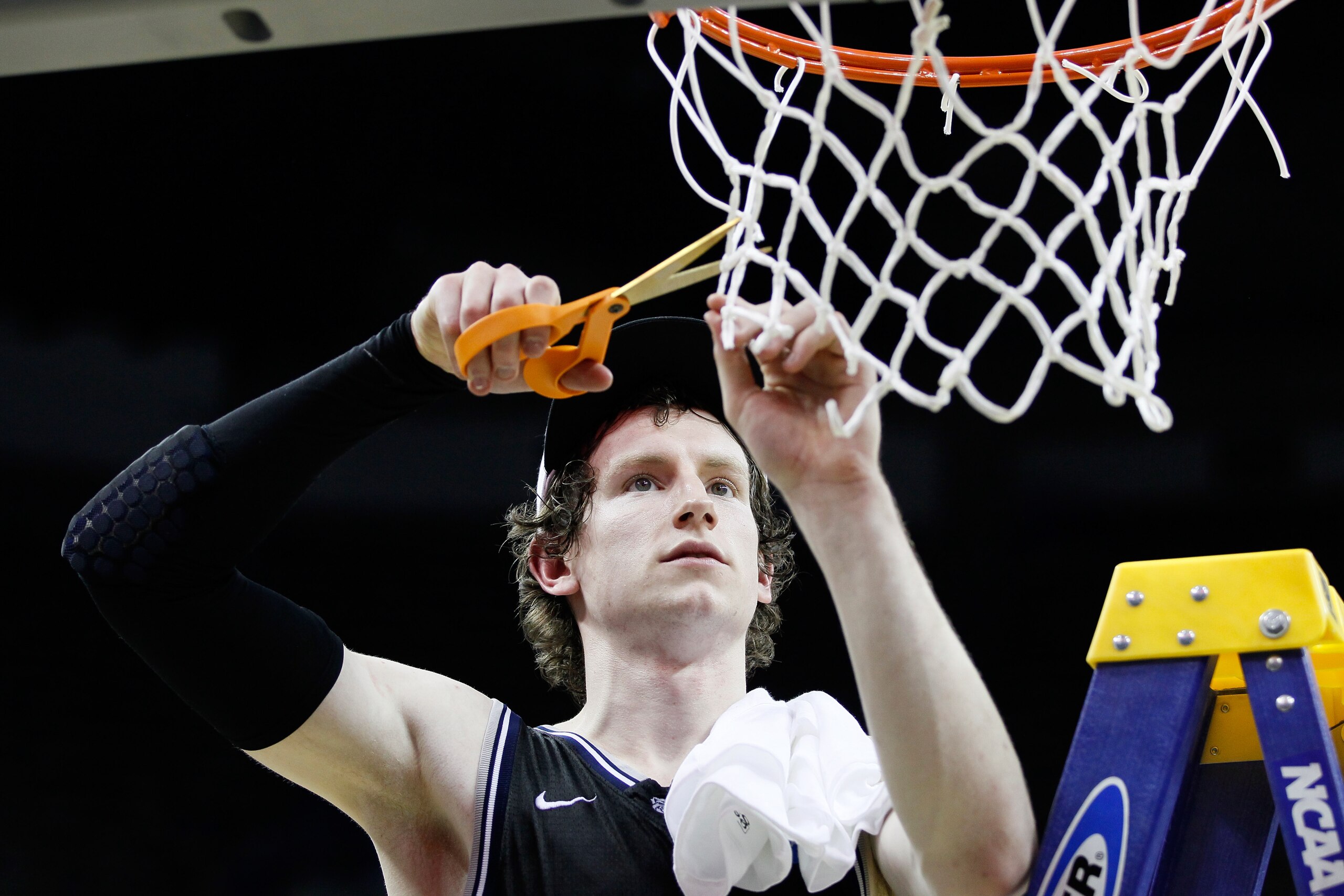 NEW ORLEANS, LA - MARCH 26:  Matt Howard #54 of the Butler Bulldogs celebrates defeating the Florida Gators 74 to 71 in overtime by cutting down part of the net during the Southeast regional final of the 2011 NCAA men's basketball tournament at New Orlean
