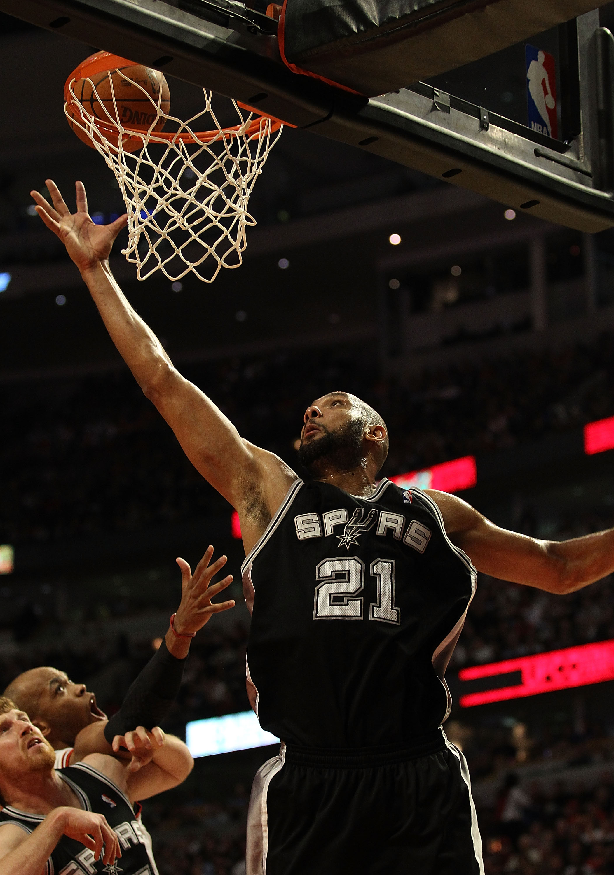 CHICAGO, IL - FEBRUARY 17: Tim Duncan #21 of the San Antonio Spurs grabs a rebound against the Chicago Bulls at the United Center on February 17, 2011 in Chicago, Illinois. The Bulls defeated the Spurs 109-99. NOTE TO USER: User expressly acknowledges and