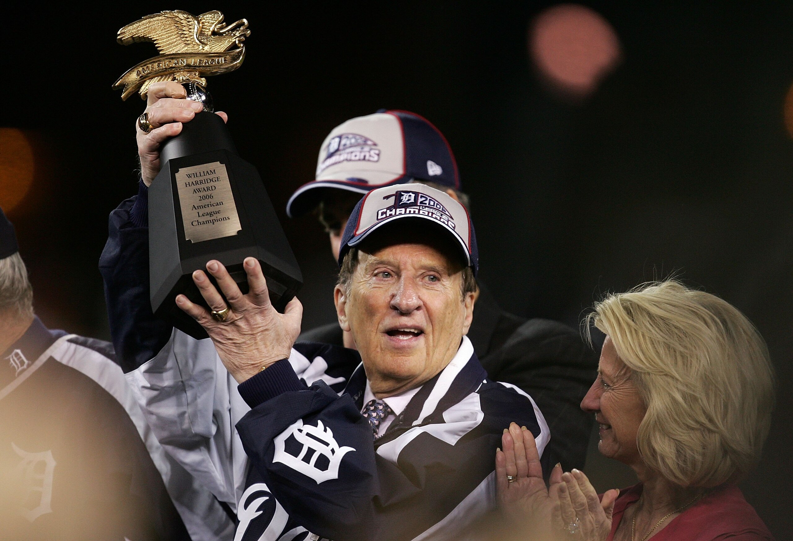 DETROIT - OCTOBER 14:  Michael Ilitch, owner of the Detroit Tigers celebrates with the AMerican League Championship trophy after the Tigers won 6-3 against the Oakland Athletics during Game Four of the American League Championship Series October 14, 2006