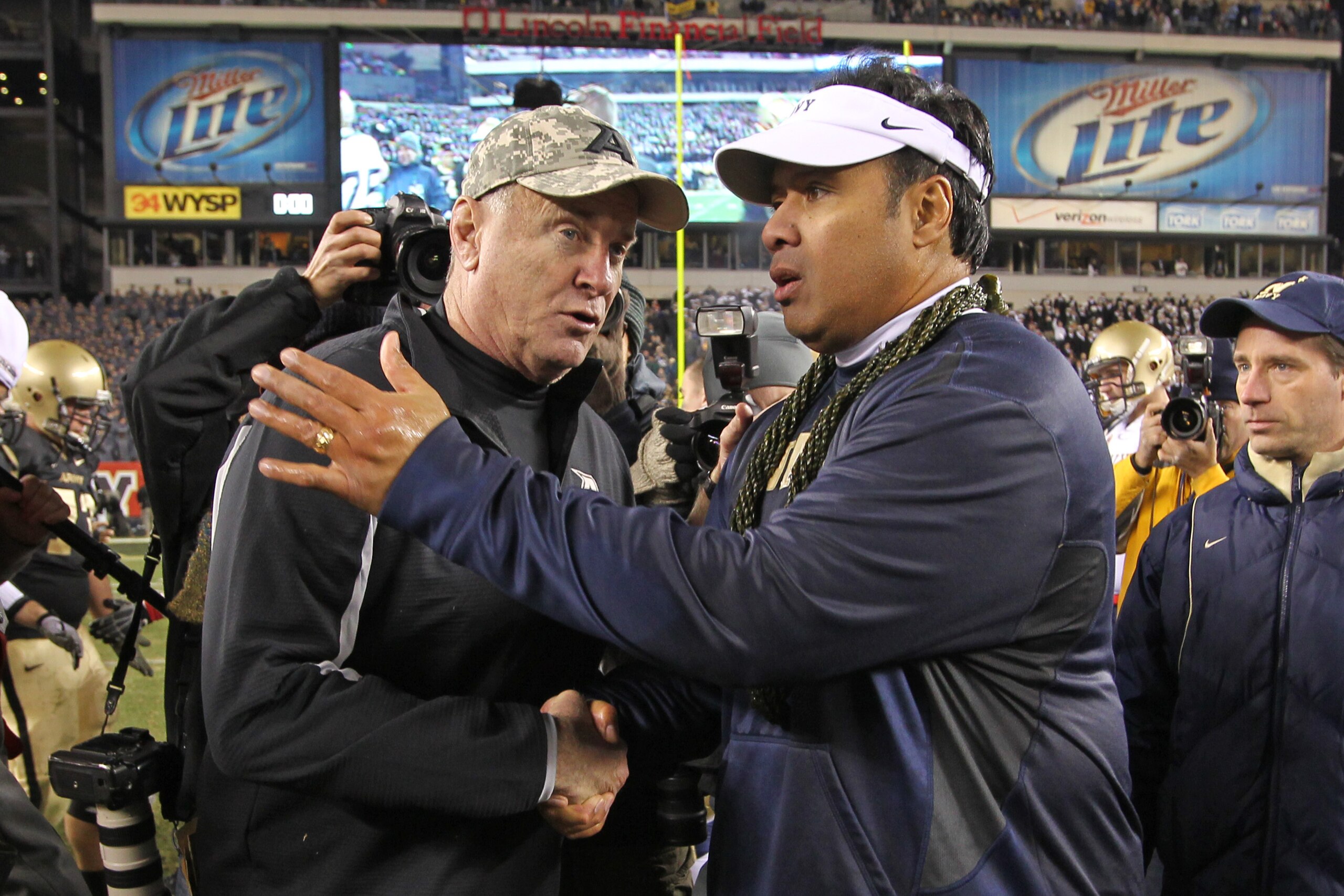 PHILADELPHIA - DECEMBER 11: Head coach Rich Ellerson of the Army Black Knights (L) shakes hands with head coach Ken Niumatalolo of the Navy Midshipmen after a game on December 11, 2010 at Lincoln Financial Field in Philadelphia, Pennsylvania. The Midshipm PHILADELPHIA - DECEMBER 11: Head coach Rich Ellerson of the Army Black Knights (L) shakes hands with head coach Ken Niumatalolo of the Navy Midshipmen after a game on December 11, 2010 at Lincoln Financial Field in Philadelphia, Pennsylvania. The Midshipm