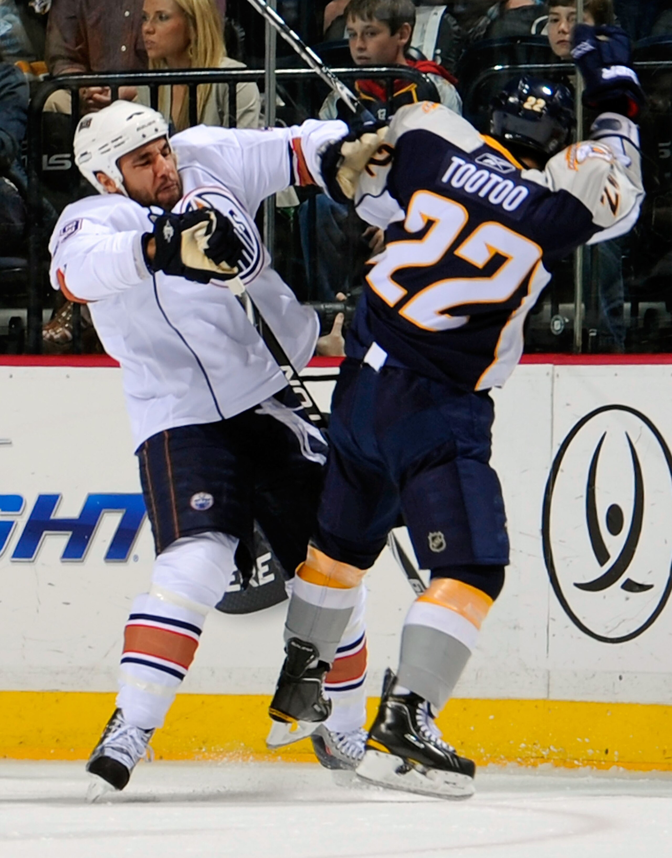 NASHVILLE, TN - MARCH 22:  Theo Peckham #49 of the Edmonton Oilers checks Jordin Tootoo #22 of the Nashville Predators on March 22, 2011 at the Bridgestone Arena in Nashville, Tennessee.  (Photo by Frederick Breedon/Getty Images)