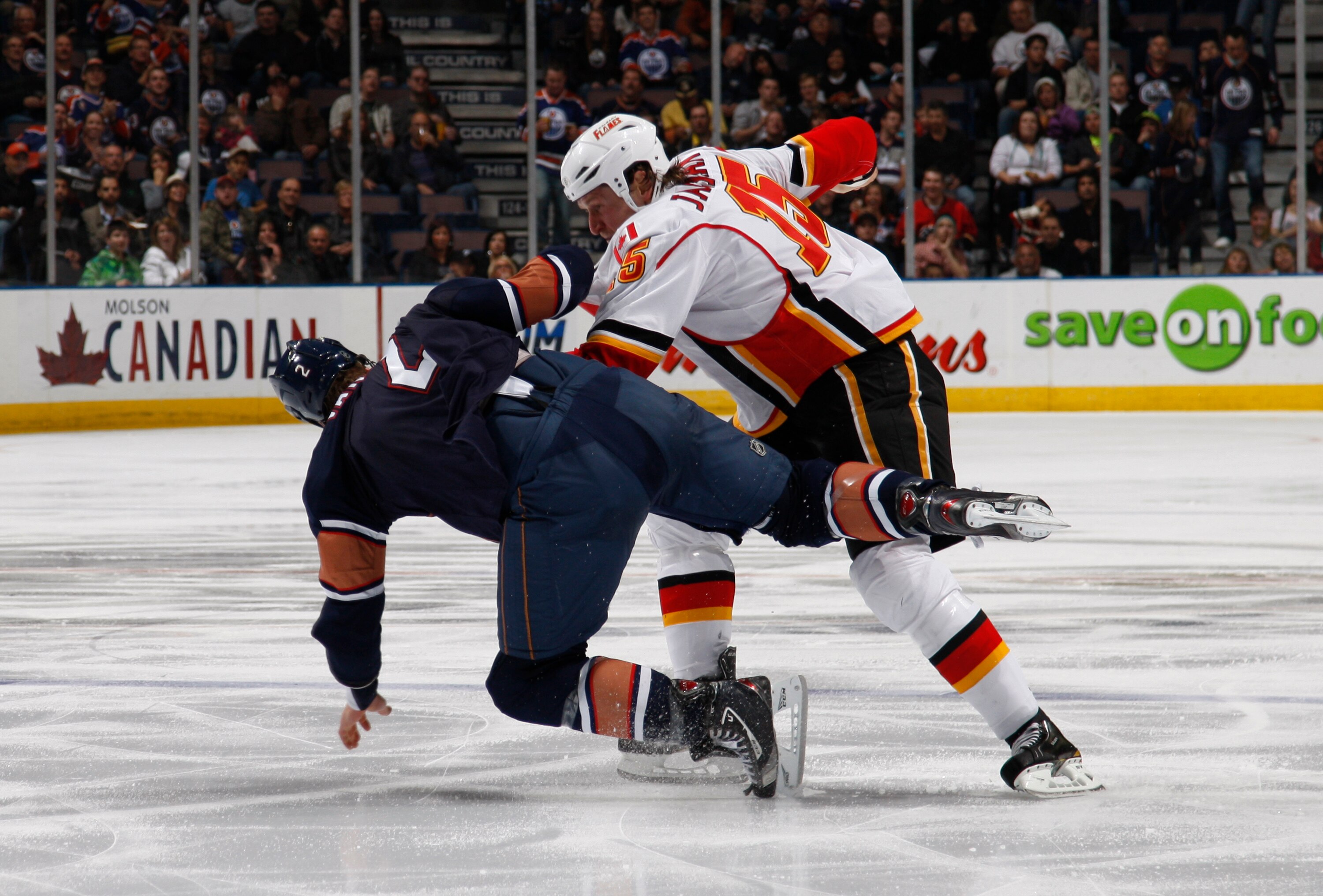 EDMONTON, CANADA - OCTOBER 1:  James Vandermeer #2 of the Edmonton Oilers fights Tim Jackman #15 of the Calgary Flames in second-period action at Rexall Place October 1, 2010 in Edmonton, Alberta, Canada. (Photo by Dale MacMillan/Getty Images)