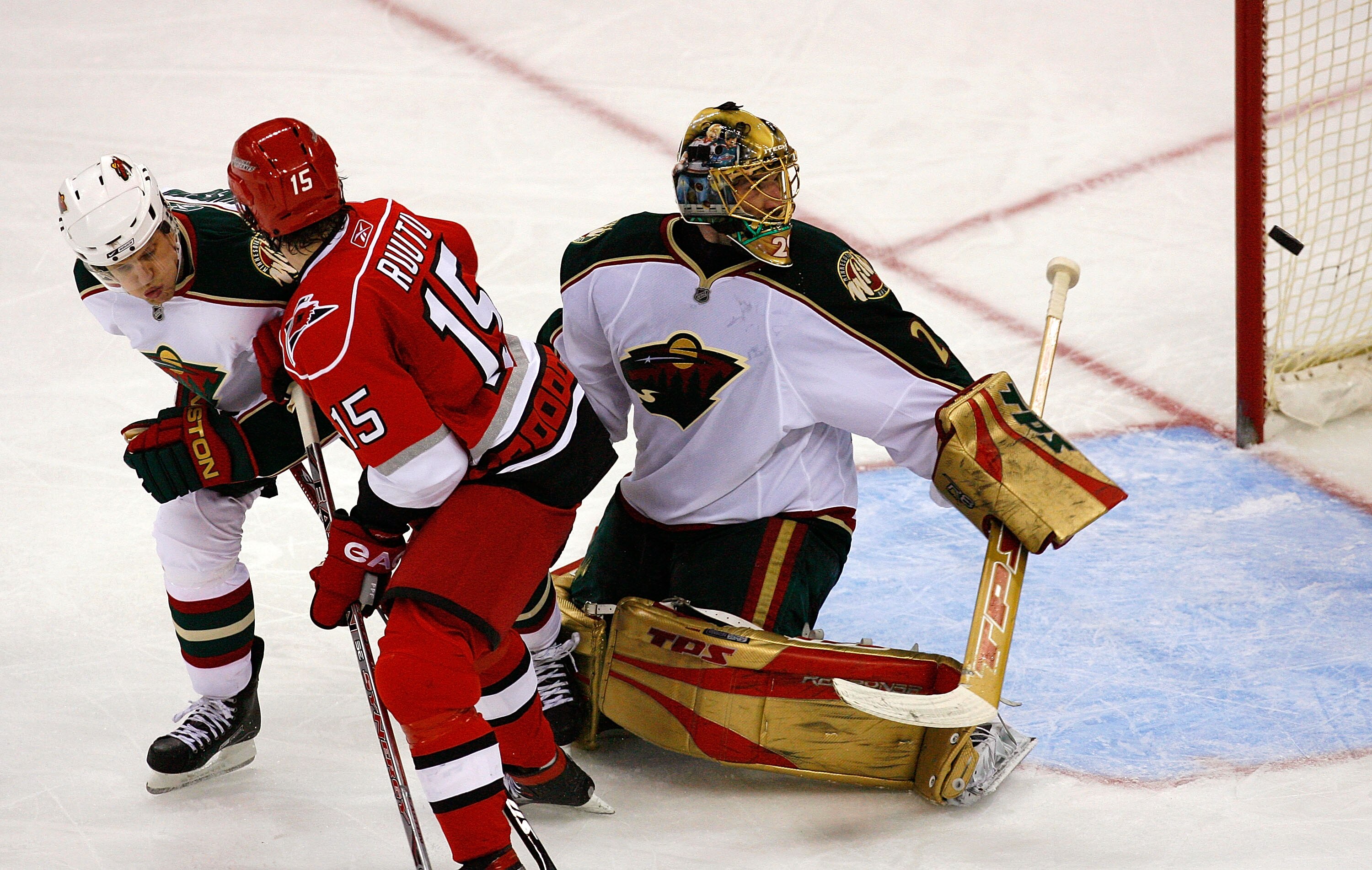 RALEIGH, NC - MARCH 06:  Tuomo Ruutu #15 of the Carolina Hurricanes battles with Kim Johnsson #5 as goaltender Josh Harding #29 of the Minnesota Wild watches a puck fly by during the third period at RBC Center on March 6, 2008 in Raleigh, North Carolina.