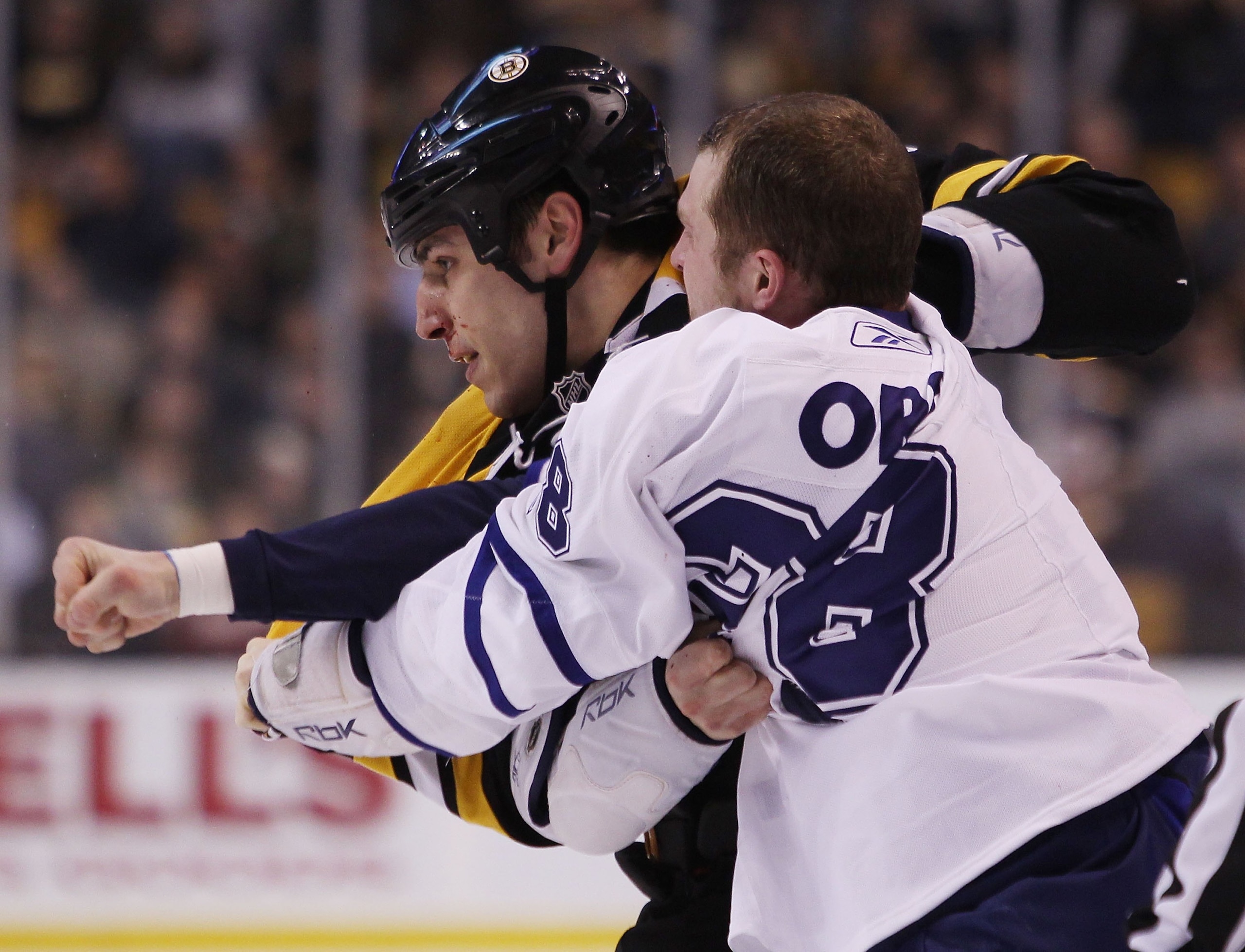 BOSTON - MARCH 04:  Colton Orr #28 of the Toronto Maple Leafs and Milan Lucic #17 of the Boston Bruins exchange punches on March 4, 2010 at the TD Garden in Boston, Massachusetts.  (Photo by Elsa/Getty Images)