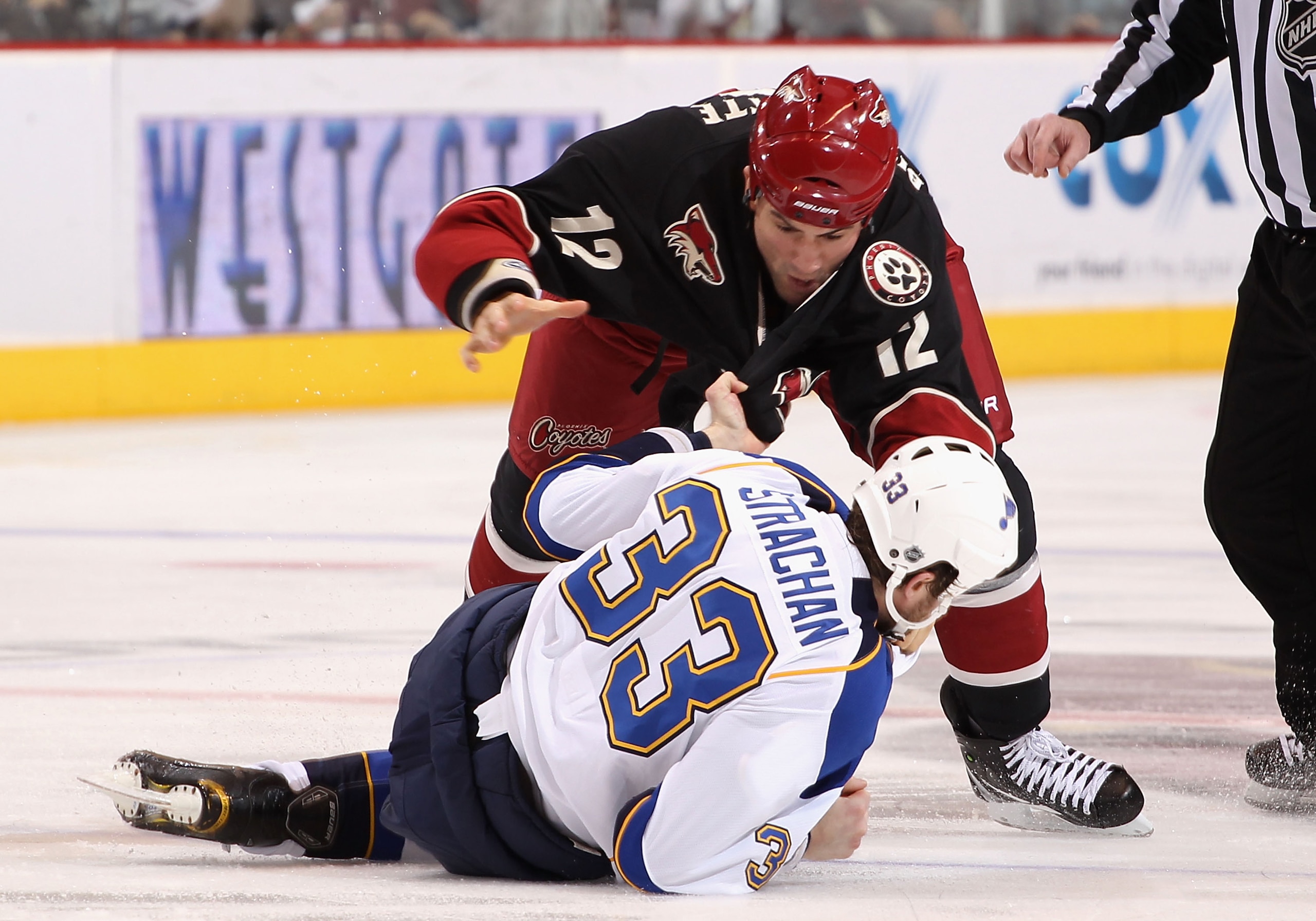 GLENDALE, AZ - MARCH 22:  Paul Bissonnette #12 of the Phoenix Coyotes fights with Tyson Strachan #33 of the St. Louis Blues during the NHL game at Jobing.com Arena on March 22, 2011 in Glendale, Arizona. The Coyotes defeated the Blues 2-1.  (Photo by Chri
