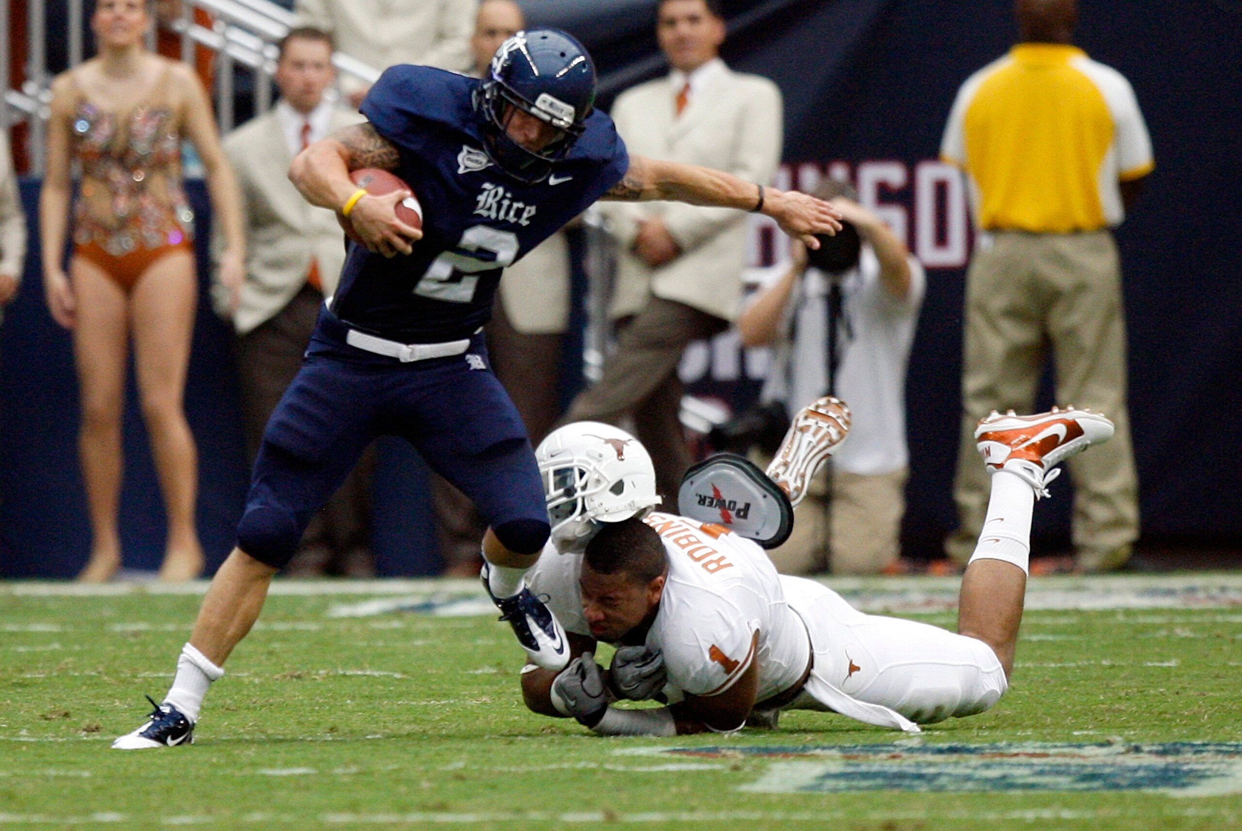 HOUSTON - SEPTEMBER 04: Running back Sam McGuffie #2 of the Rice Owls is tackled by linebacker Keenan Robinson #1 of the Texas Longhorns at Reliant Stadium on September 4, 2010 in Houston, Texas. (Photo by Bob Levey/Getty Images) HOUSTON - SEPTEMBER 04: Running back Sam McGuffie #2 of the Rice Owls is tackled by linebacker Keenan Robinson #1 of the Texas Longhorns at Reliant Stadium on September 4, 2010 in Houston, Texas. (Photo by Bob Levey/Getty Images)