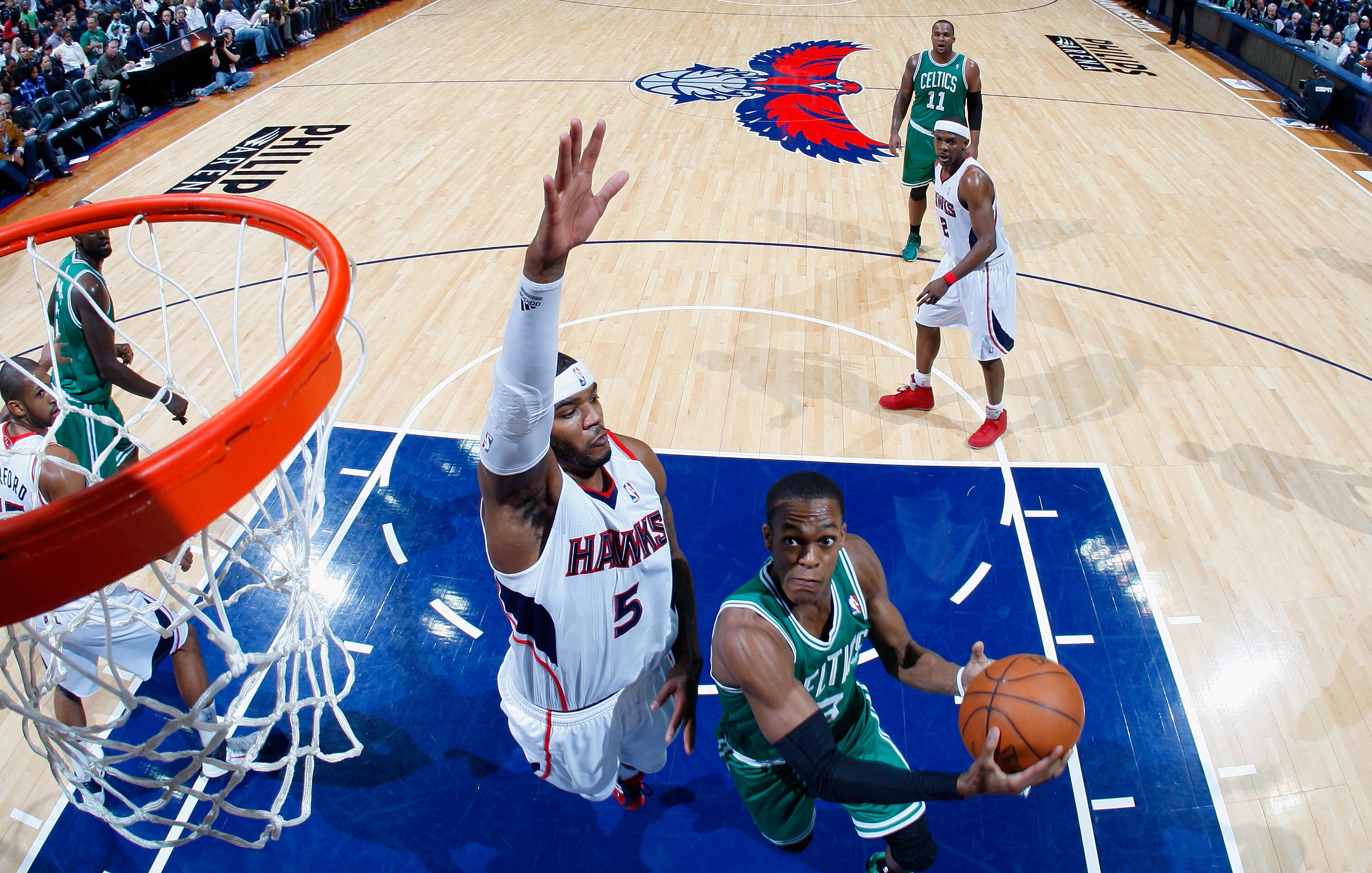 ATLANTA, GA - APRIL 01:  Rajon Rondo #9 of the Boston Celtics drives against Josh Smith #5 of the Atlanta Hawks at Philips Arena on April 1, 2011 in Atlanta, Georgia.  NOTE TO USER: User expressly acknowledges and agrees that, by downloading and/or using