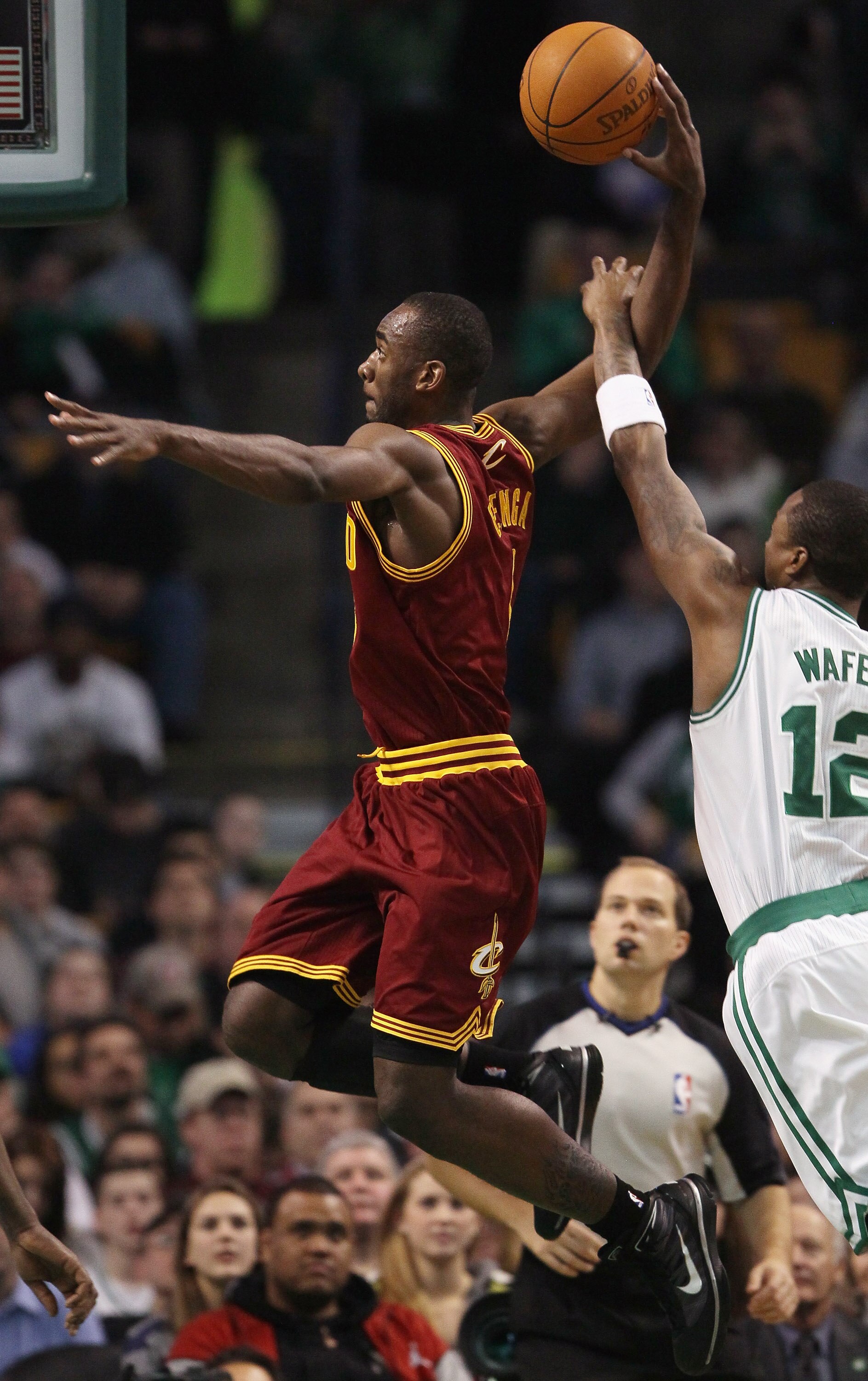 BOSTON, MA - JANUARY 25:  Christian Eyenga #8 of the of the Cleveland Cavaliers heads for the basket and fouled by Von Wafer #12 of the Boston Celtics on January 25, 2011 at the TD Garden in Boston, Massachusetts. The Celtics defeated the Cavaliers 112-95