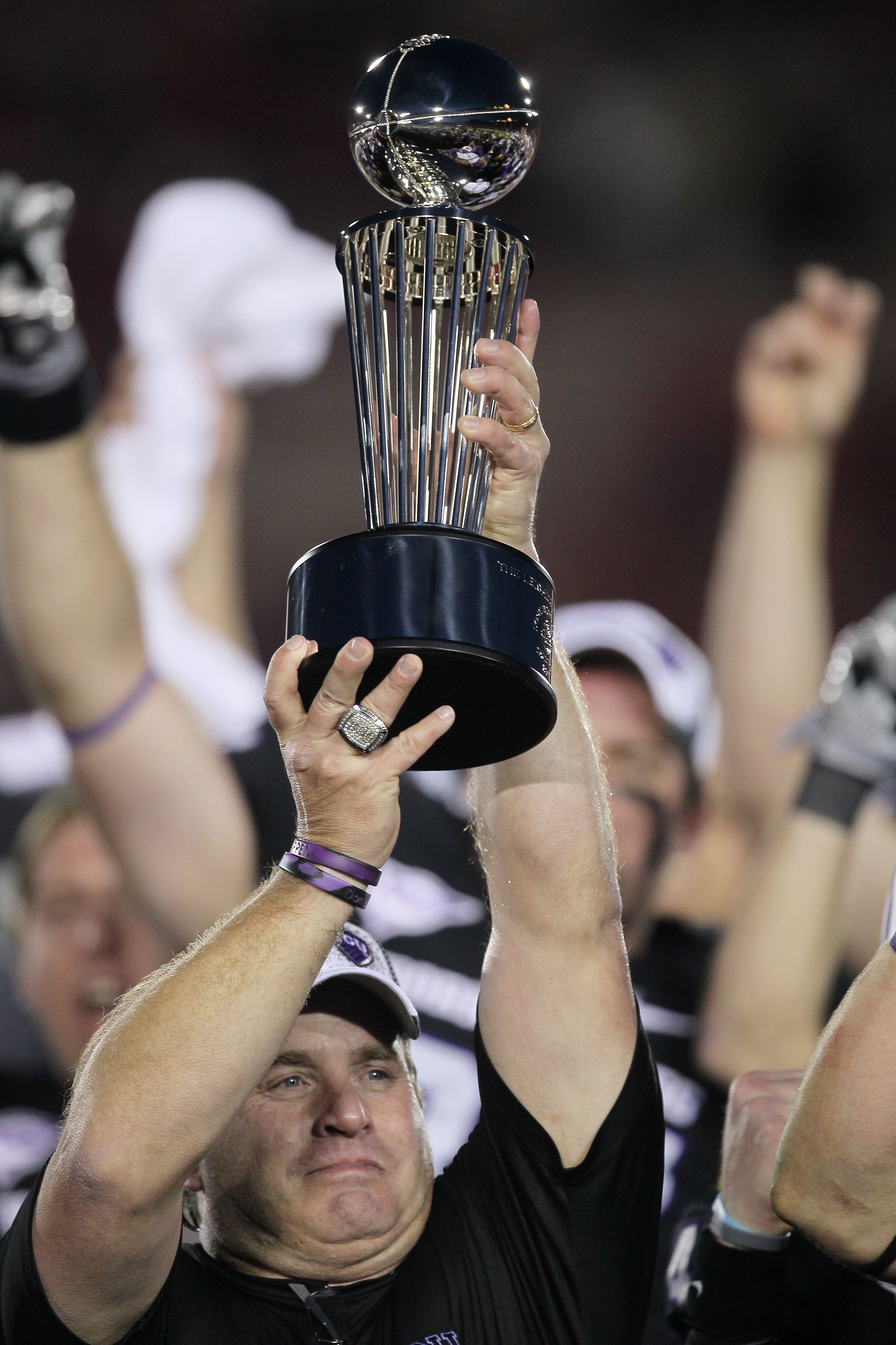 PASADENA, CA - JANUARY 01:  Head coach Gary Patterson of the TCU Horned Frogs holds the Rose Bowl Championship Trophy after defeating the Wisconsin Badgers 21-19 in the 97th Rose Bowl game on January 1, 2011 in Pasadena, California.  (Photo by Stephen Dun