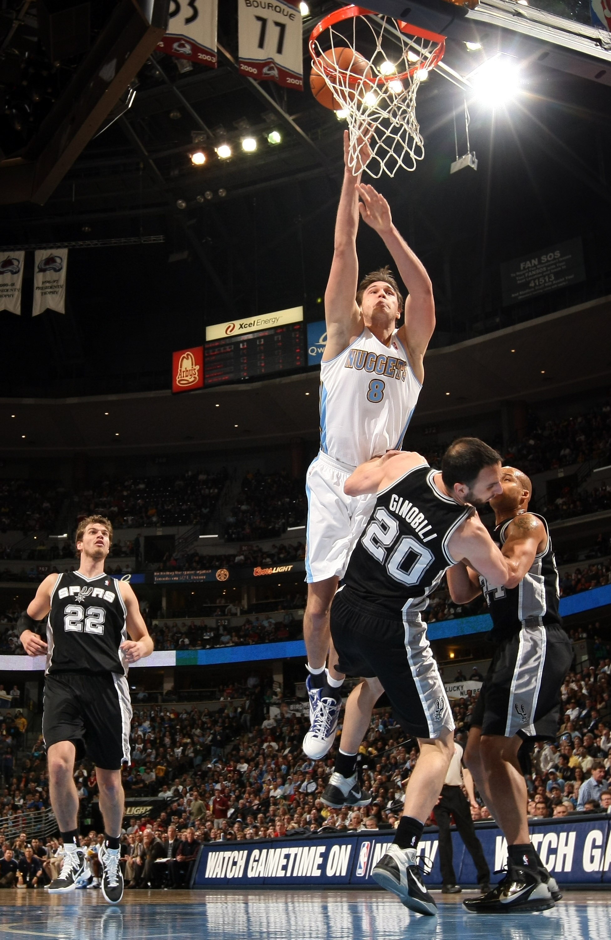 DENVER, CO - MARCH 23:  Danilo Gallinari #8 of the Denver Nuggets goes up for a shot and is fouled by Manu Ginobili #20 of the San Antonio Spurs at the Pepsi Center on March 23, 2011 in Denver, Colorado. The Nuggets defeated the Spurs 115-112. NOTE TO USE