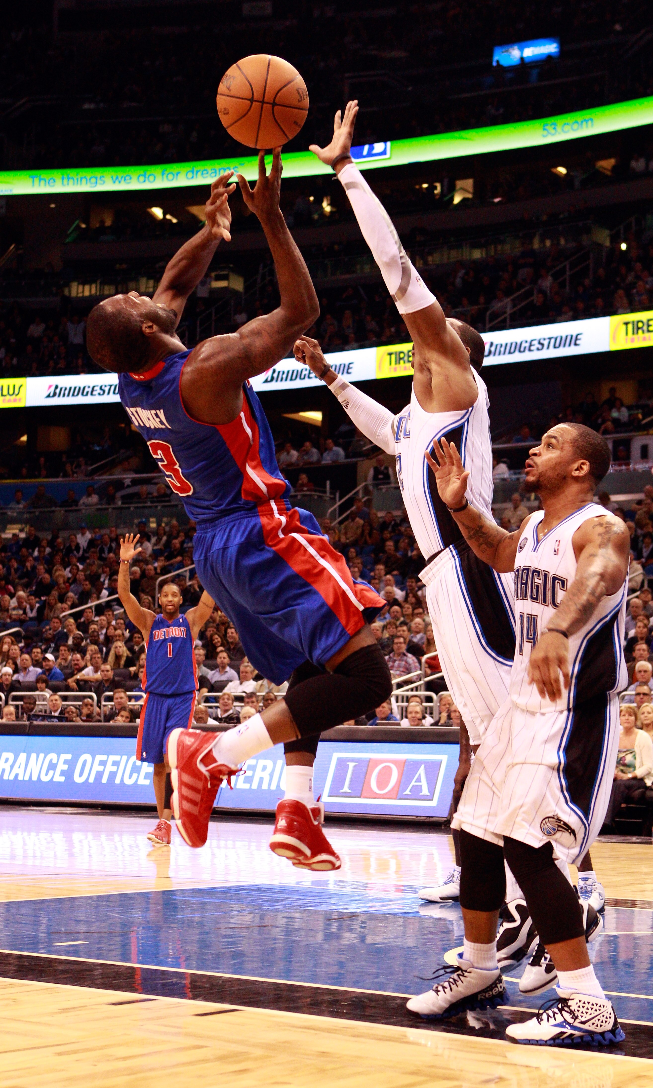 ORLANDO, FL - JANUARY 24:   Rodney Stuckey #3 of the Detroit Pistons attempts a shot against Dwight Howard #12 and Jameer Nelson #14 of the Orlando Magic during the game at Amway Arena on January 24, 2011 in Orlando, Florida.  NOTE TO USER: User expressly