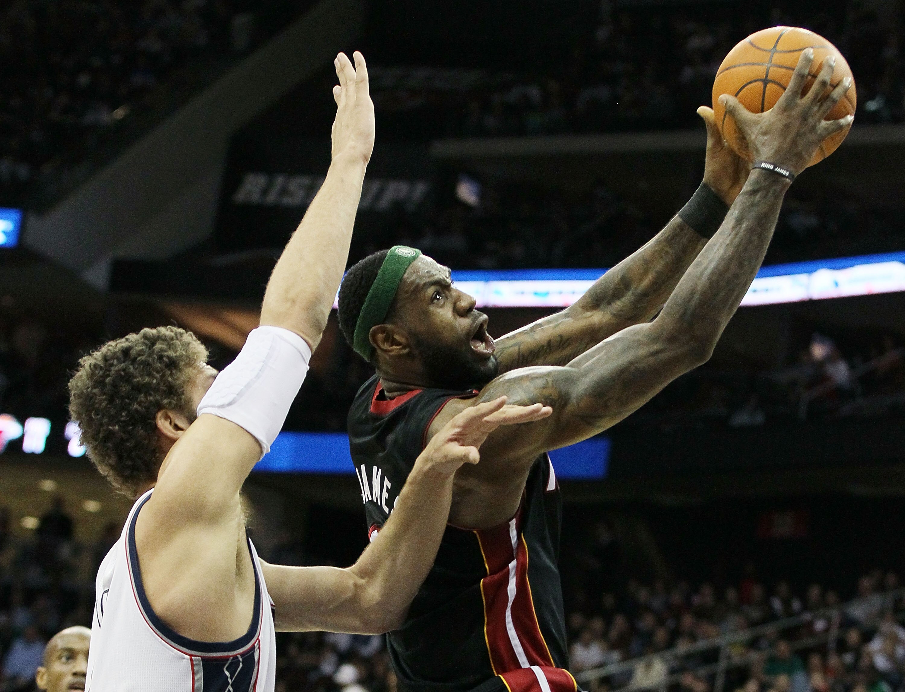 NEWARK, NJ - APRIL 03:  LeBron James #6 of the Miami Heat lays up a basket against Brook Lopez #11 of the New Jersey Nets at the Prudential Center on April 3, 2011 in Newark, New Jersey.NOTE TO USER: User expressly acknowledges and agrees that, by downloa