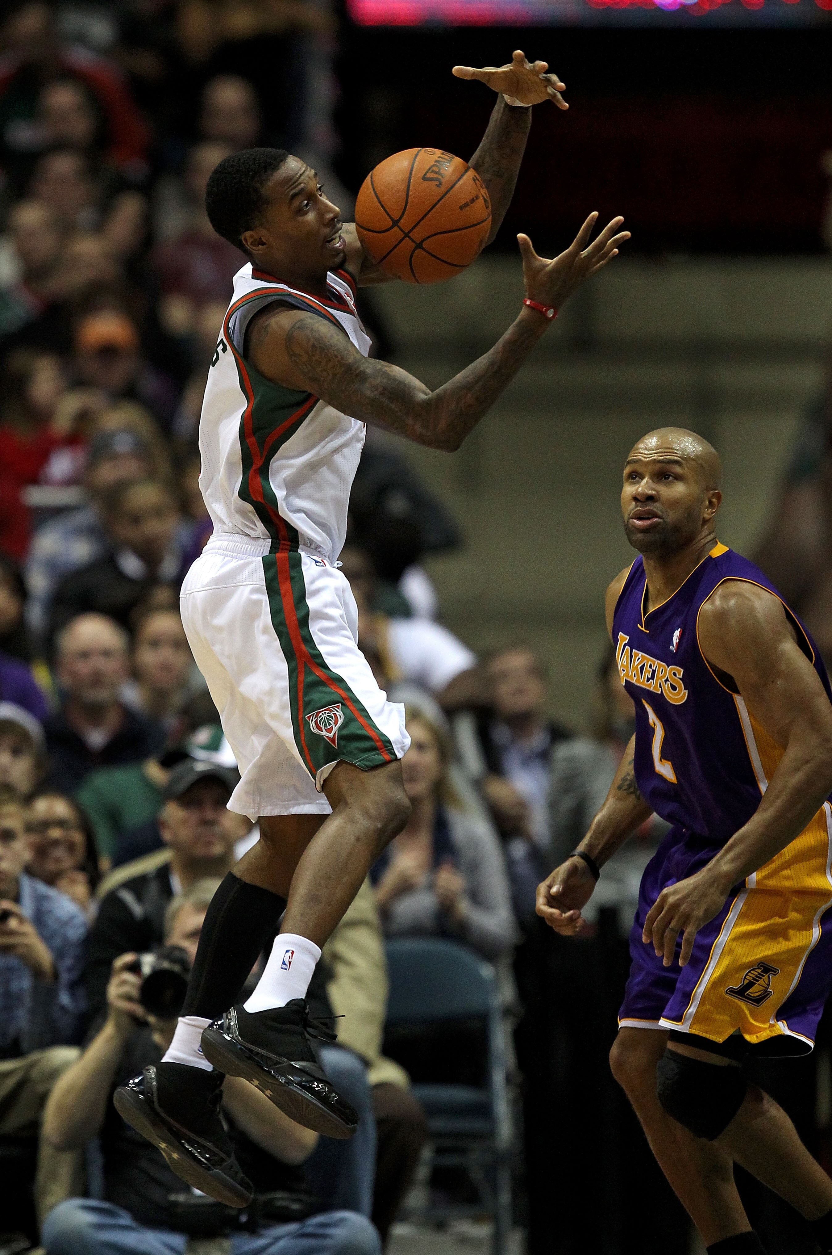 MILWAUKEE - NOVEMBER 16: Brandon Jennings #3 of the Milwaukee Bucks grabs the ball in front of Derek Fisher #2 of the Los Angeles Lakers at the Bradley Center on November 16, 2010 in Milwaukee, Wisconsin. The Lakers defeated the Bucks 118-107. NOTE TO USE