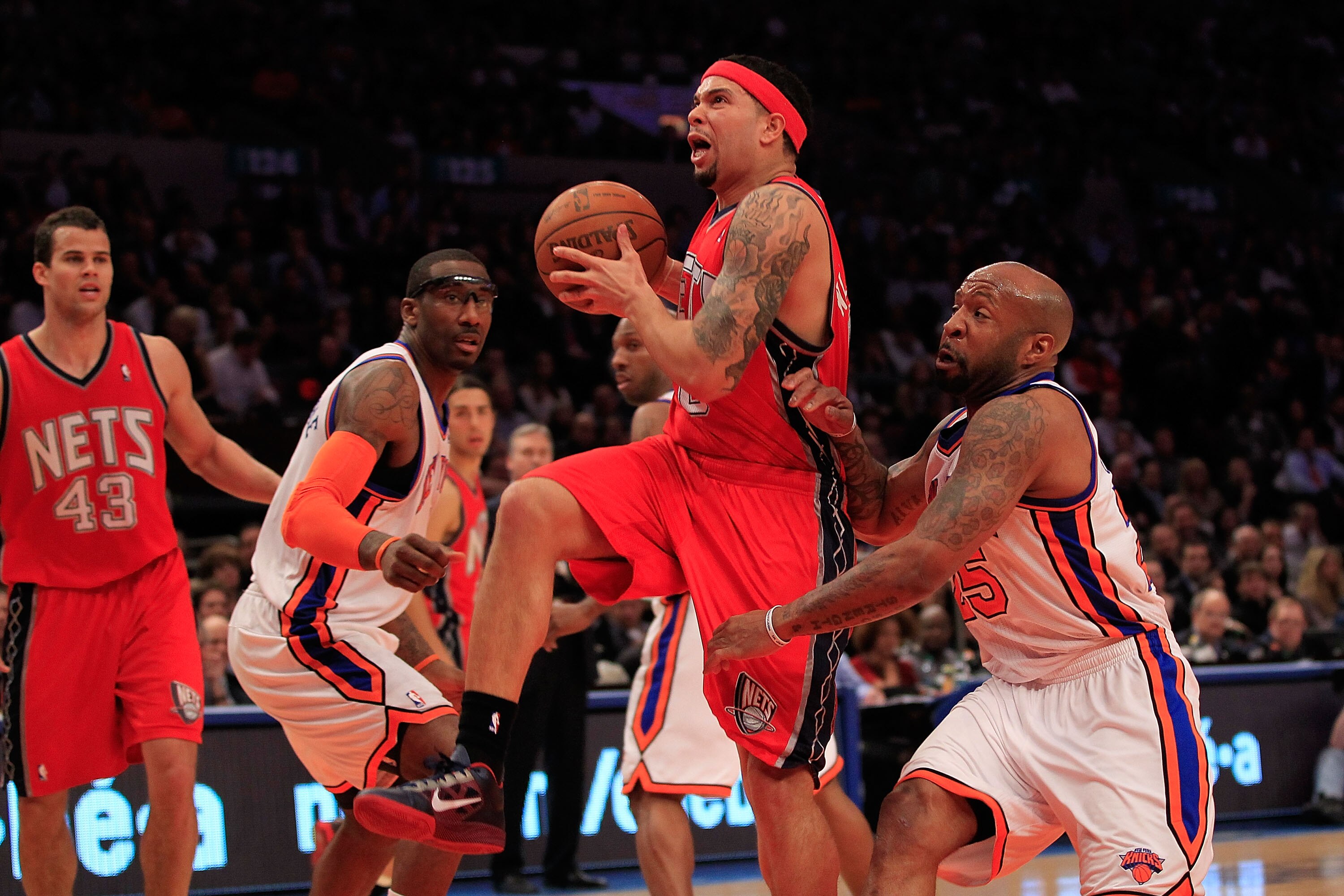 NEW YORK, NY - MARCH 30:  Deron Williams #8 of the New Jersey Nets drives against Anthony Carter#25 of the New York Knicks at Madison Square Garden on March 30, 2011 in New York City. NOTE TO USER: User expressly acknowledges and agrees that, by downloadi