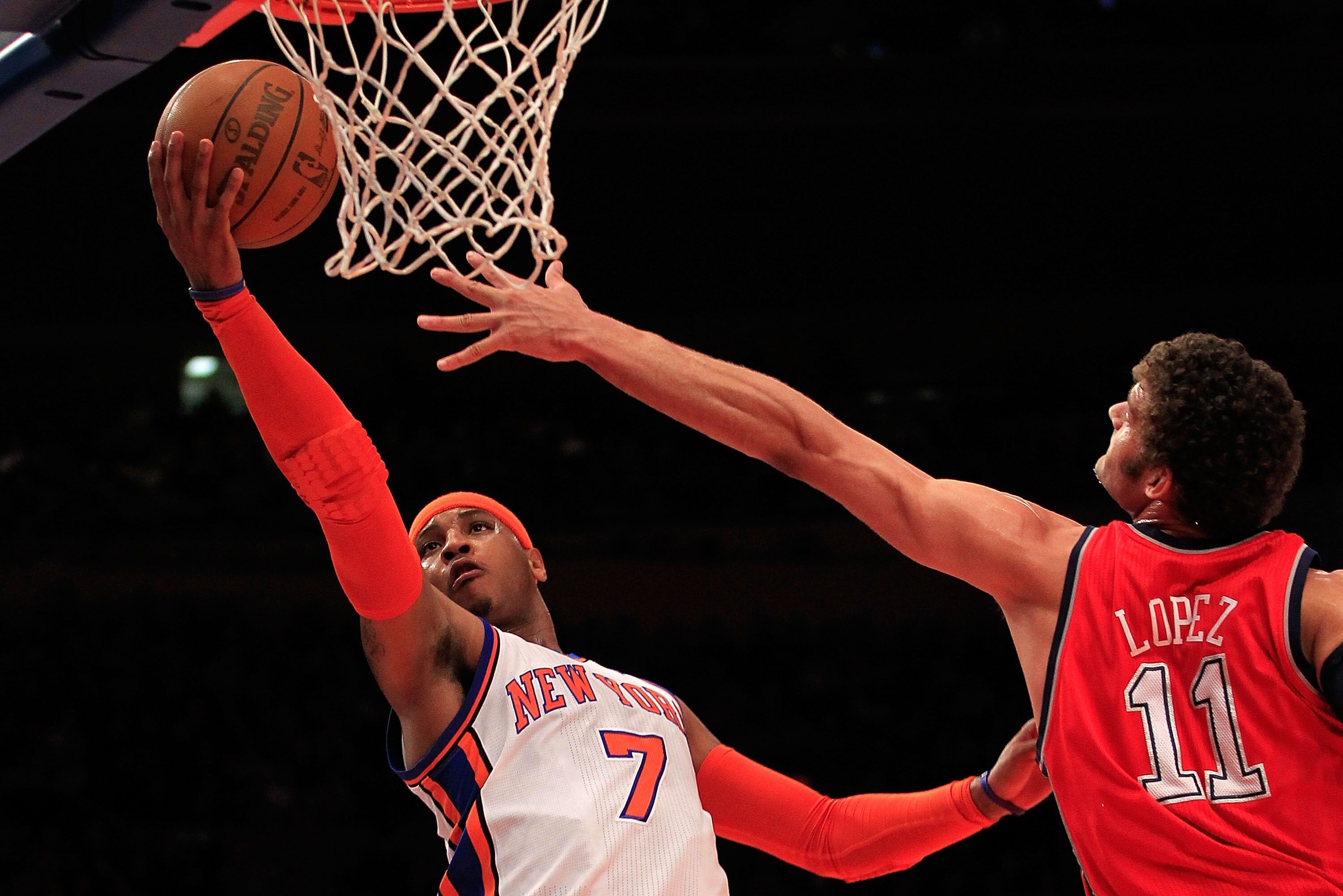 NEW YORK, NY - MARCH 30:  Carmelo Anthony #7 of the New York Knicks shoots over Brook Lopez #11 of the New Jersey Nets at Madison Square Garden on March 30, 2011 in New York City. NOTE TO USER: User expressly acknowledges and agrees that, by downloading a
