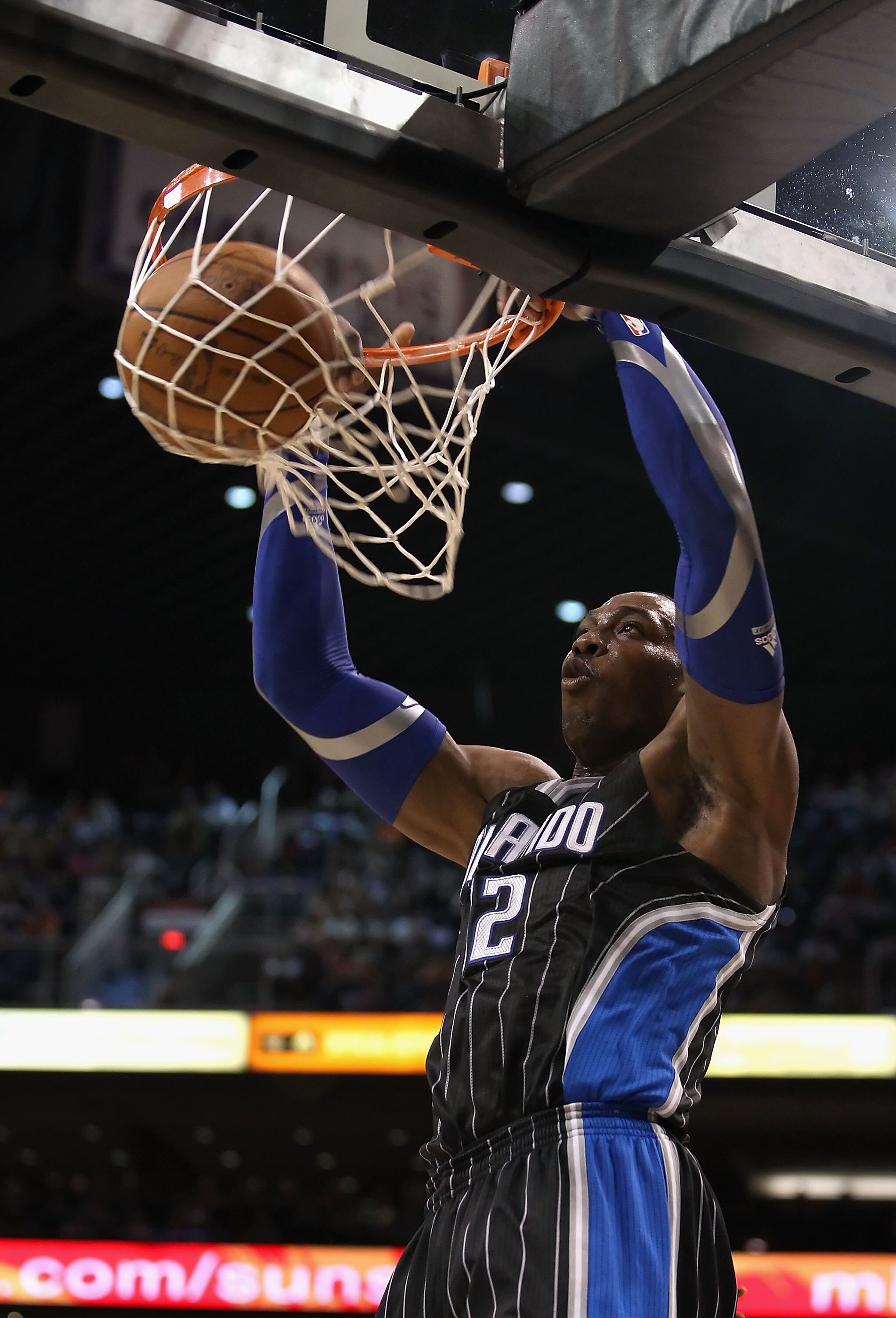 PHOENIX, AZ - MARCH 13:  Dwight Howard #12 of the Orlando Magic slam dunks the ball against the Phoenix Suns during the NBA game at US Airways Center on March 13, 2011 in Phoenix, Arizona.  NOTE TO USER: User expressly acknowledges and agrees that, by dow