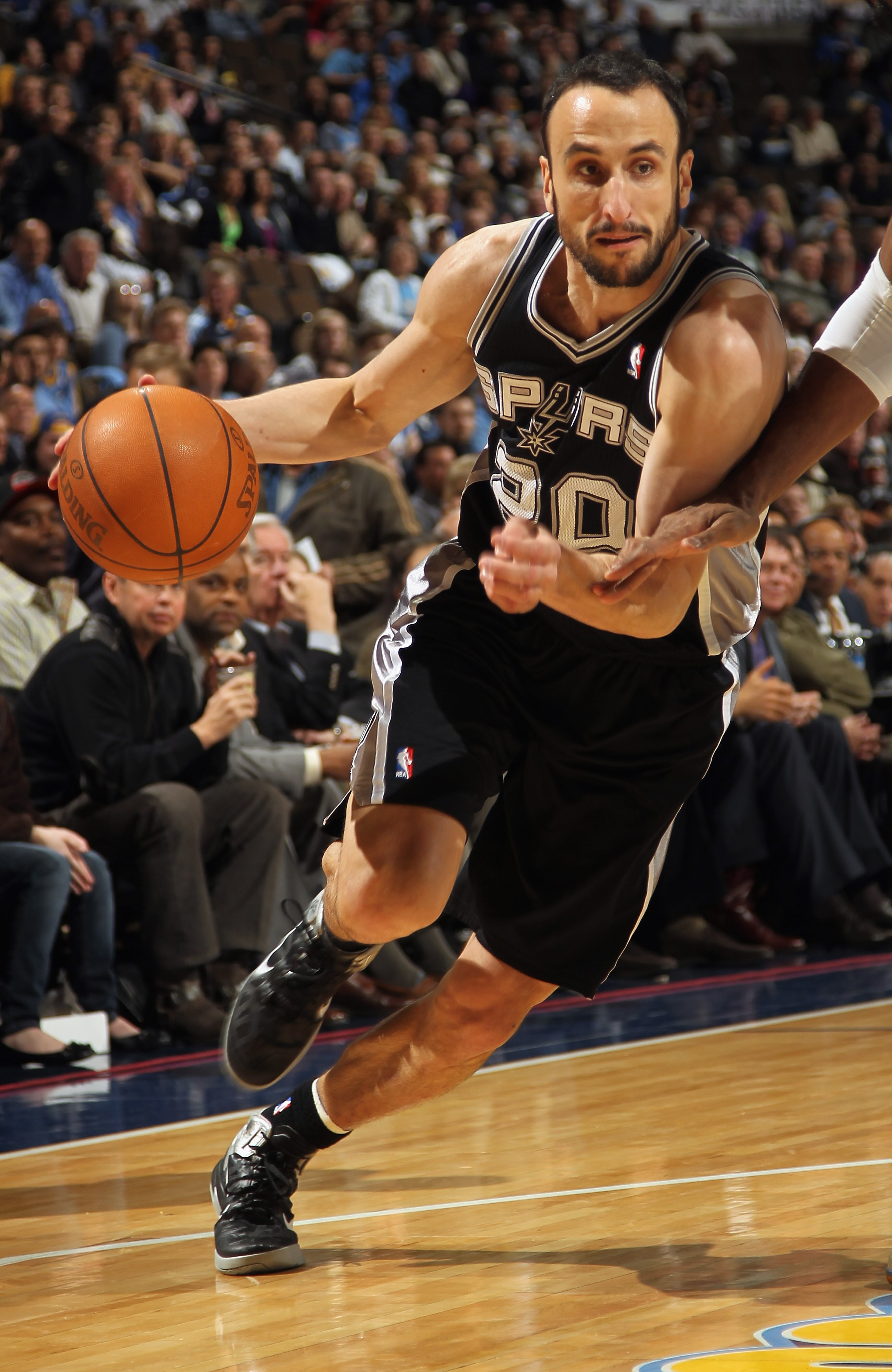 DENVER, CO - MARCH 23:  Manu Ginobili #20 of the San Antonio Spurs drives to the basket against the Denver Nuggets at the Pepsi Center on March 23, 2011 in Denver, Colorado. The Nuggets defeated the Spurs 115-112. NOTE TO USER: User expressly acknowledges