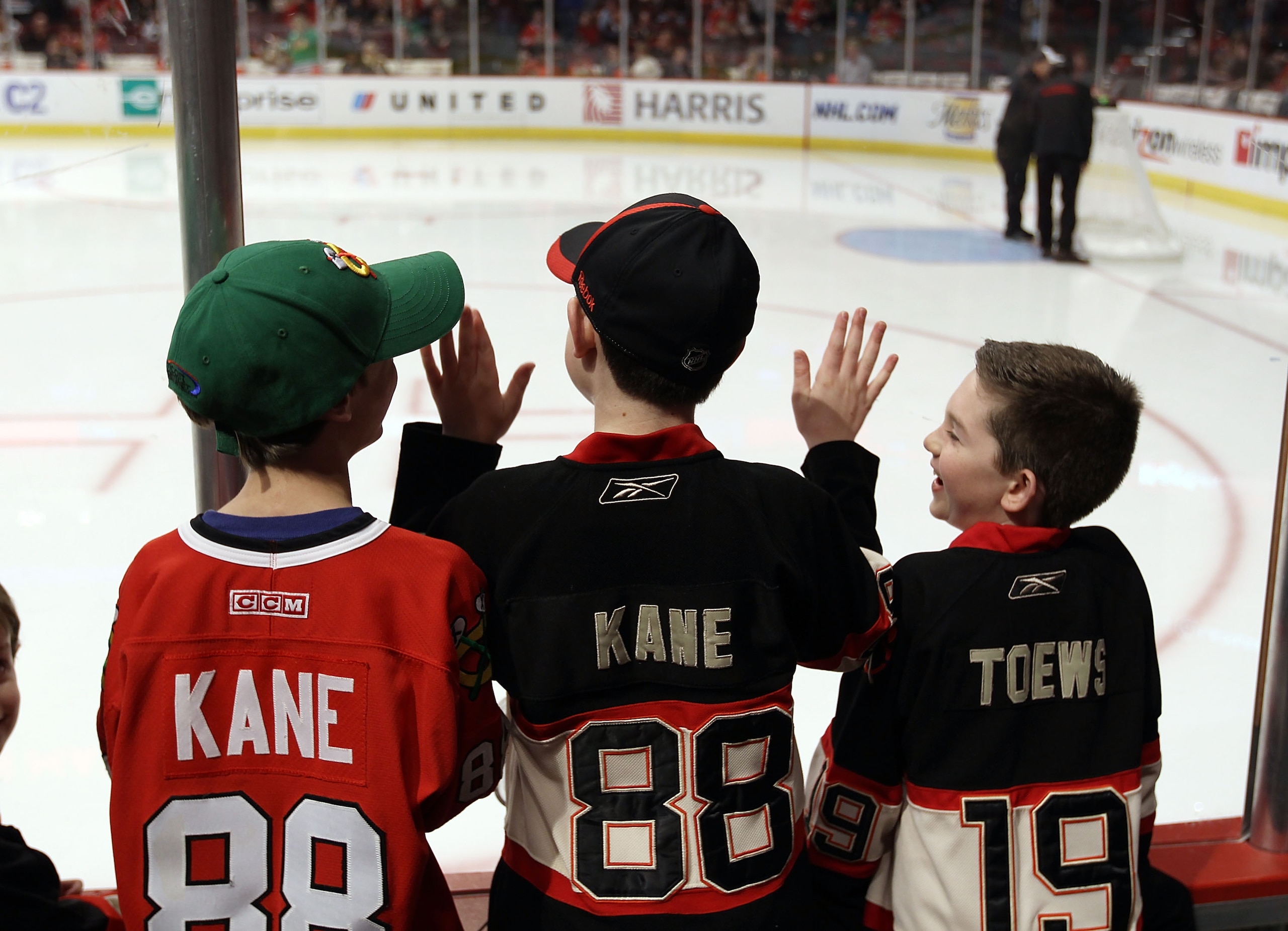 CHICAGO, IL - MARCH 23: Fans line the glass during warmups looking for pucks prior to the game between the Chicago Blackhawks and the Florida Panthers at the United Center on March 23, 2011 in Chicago, Illinois.  (Photo by Bruce Bennett/Getty Images)