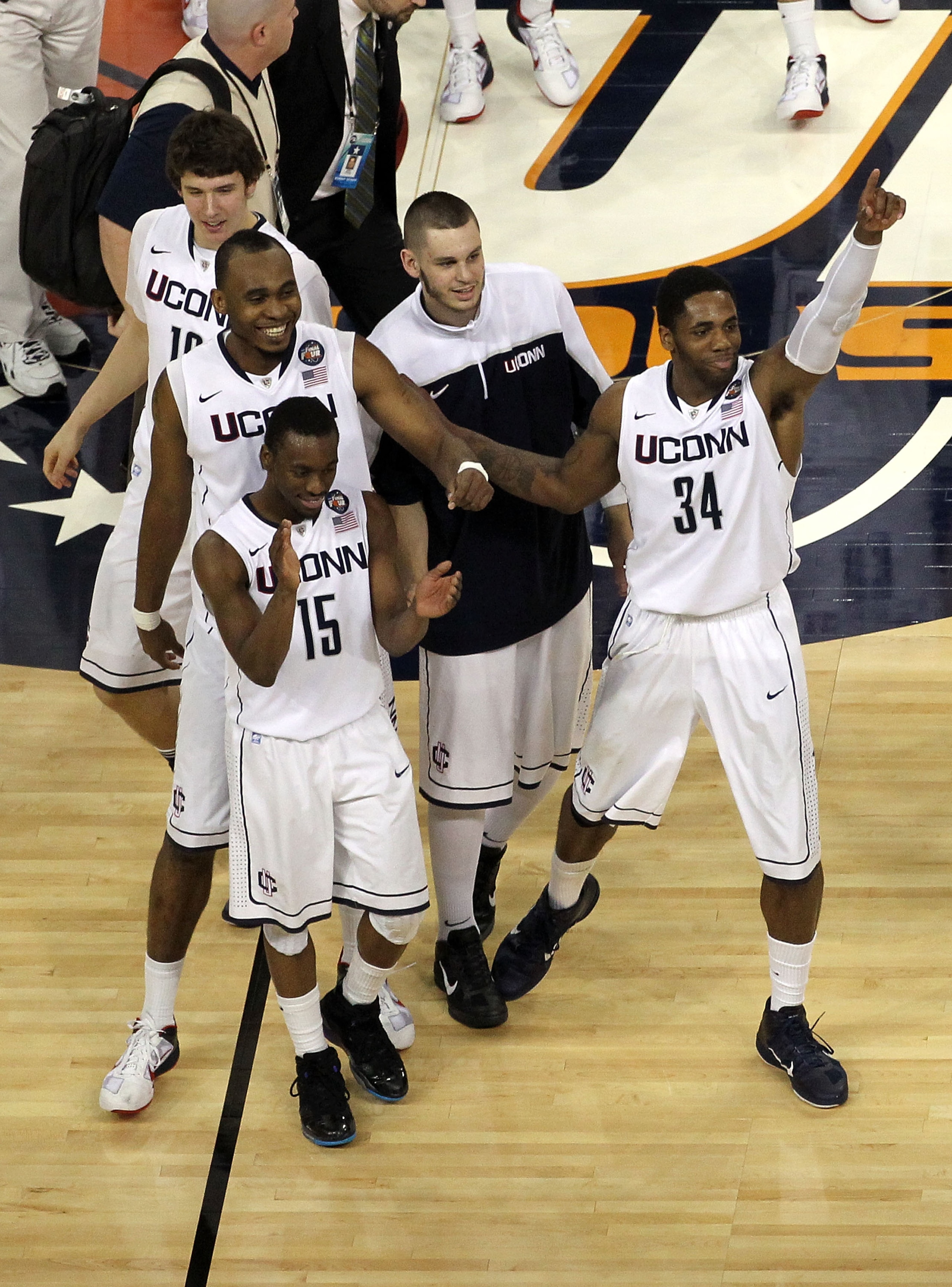 HOUSTON, TX - APRIL 02:  Kemba Walker #15, Charles Okwandu #35 and Alex Oriakhi #34 of the Connecticut Huskies celebrate after defeating the Kentucky Wildcats during the National Semifinal game of the 2011 NCAA Division I Men's Basketball Championship at