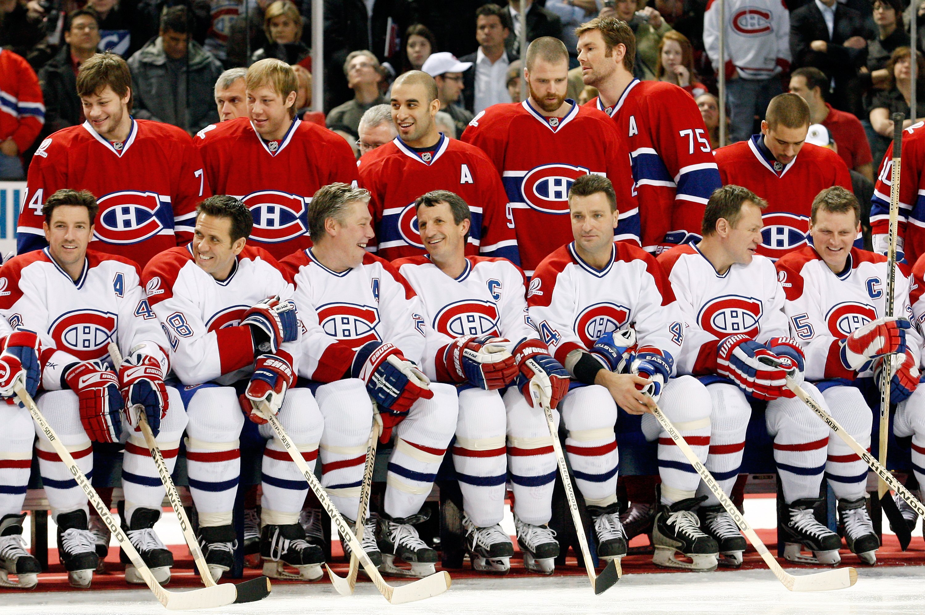 MONTREAL- DECEMBER 4:  Former Montreal Canadiens (Front Row L-R) Patrice Brisebois, Eric Desjardins, Lyle Odelein, Guy Carbonneau, Stephane Richer, Claude Lemieux and Vincent Damphousse sir in front of current Montreal Canadiens (Back Row L-R) Sergei Kost