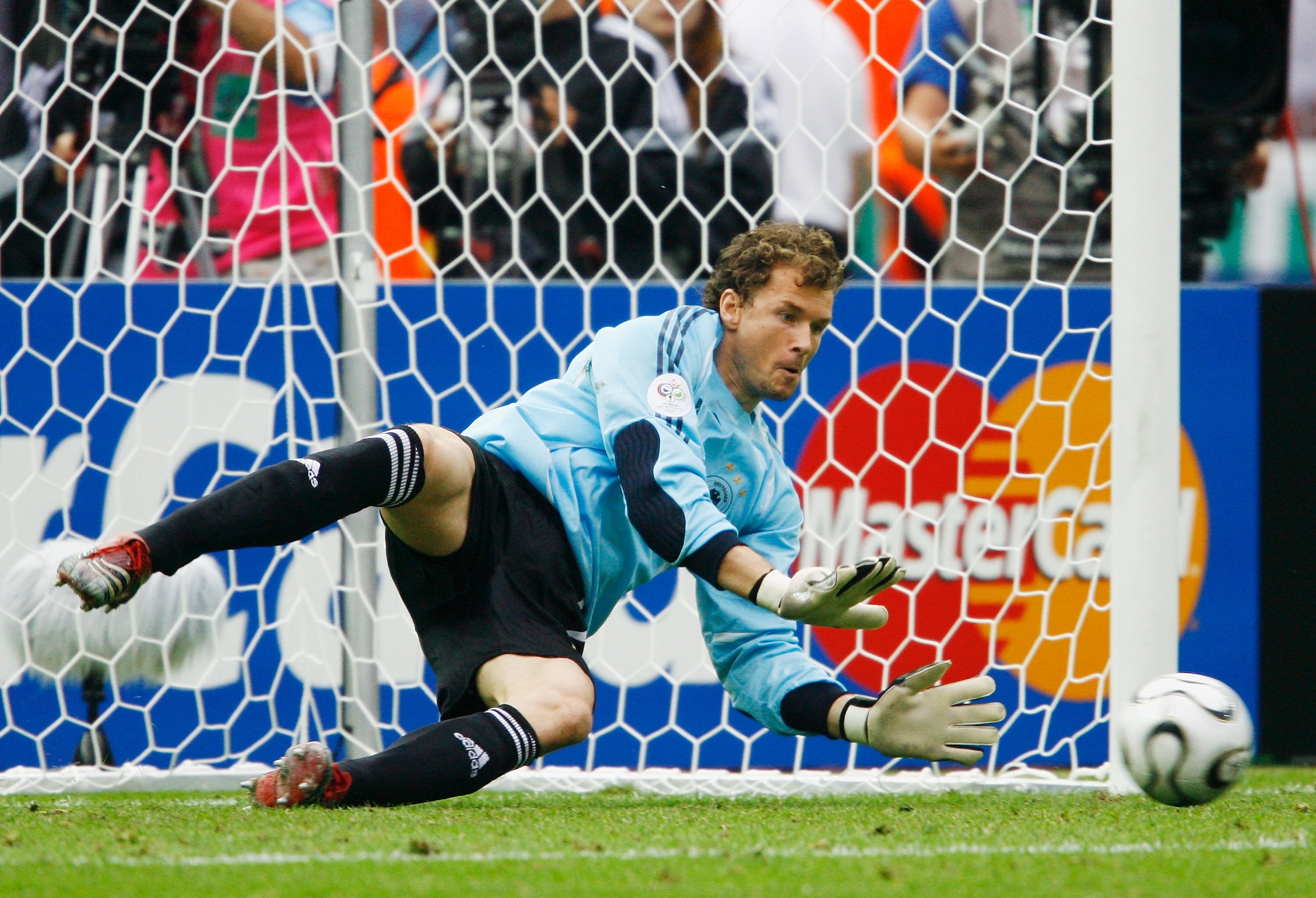 BERLIN - JUNE 30:  Jens Lehmann of Germany dives to save a penalty taken by Roberto Ayala of Argentina in a penalty shootout during the FIFA World Cup Germany 2006 Quarter-final match between Germany and Argentina played at the Olympic Stadium on June 30,