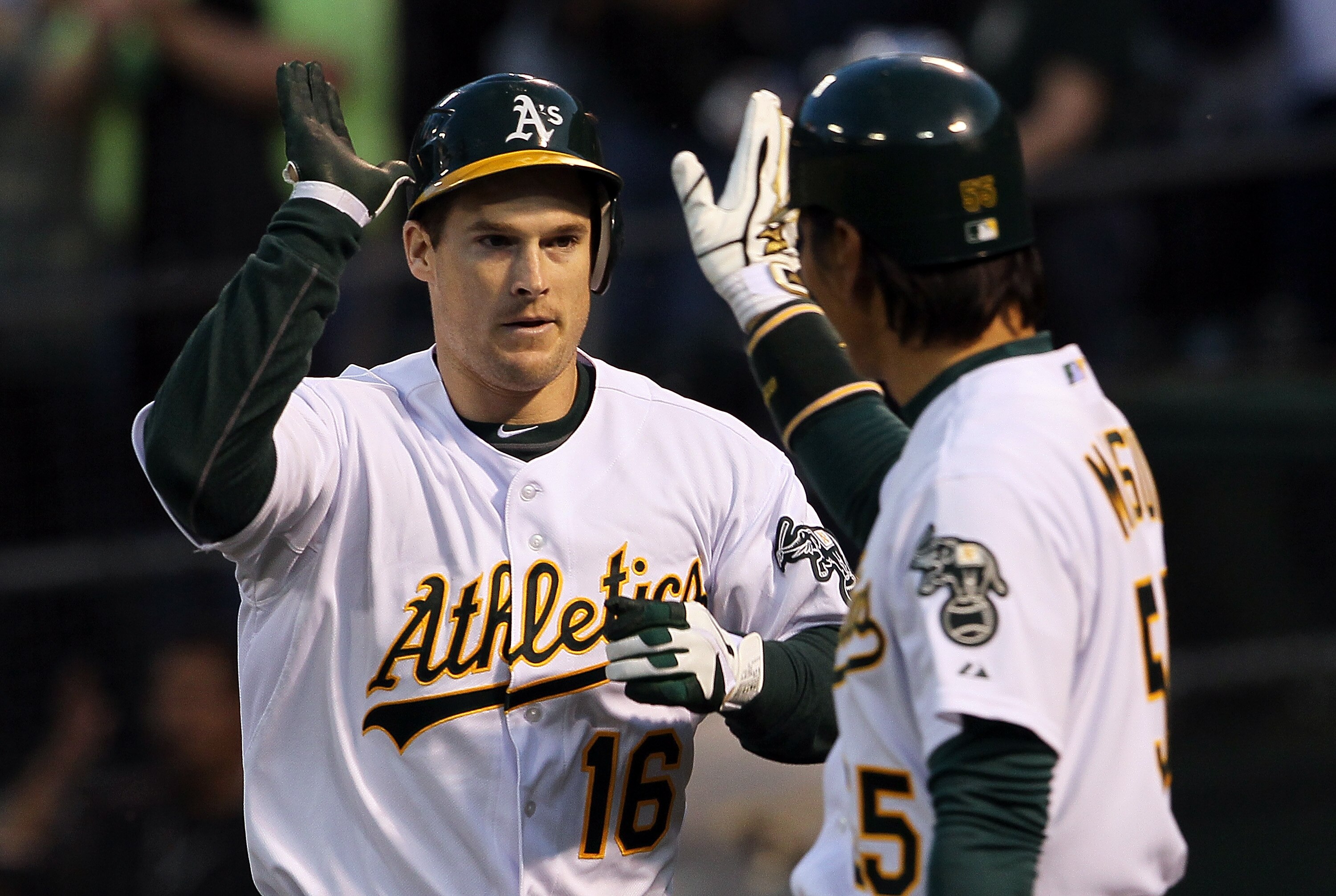 OAKLAND, CA - APRIL 01:  Josh Willingham #16 of the Oakland Athletics is congratulated by Hideki Matsui #55 after hitting a two-run home run during the first inning against the Seattle Mariners at the Oakland-Alameda County Coliseum on April 1, 2011 in Oa