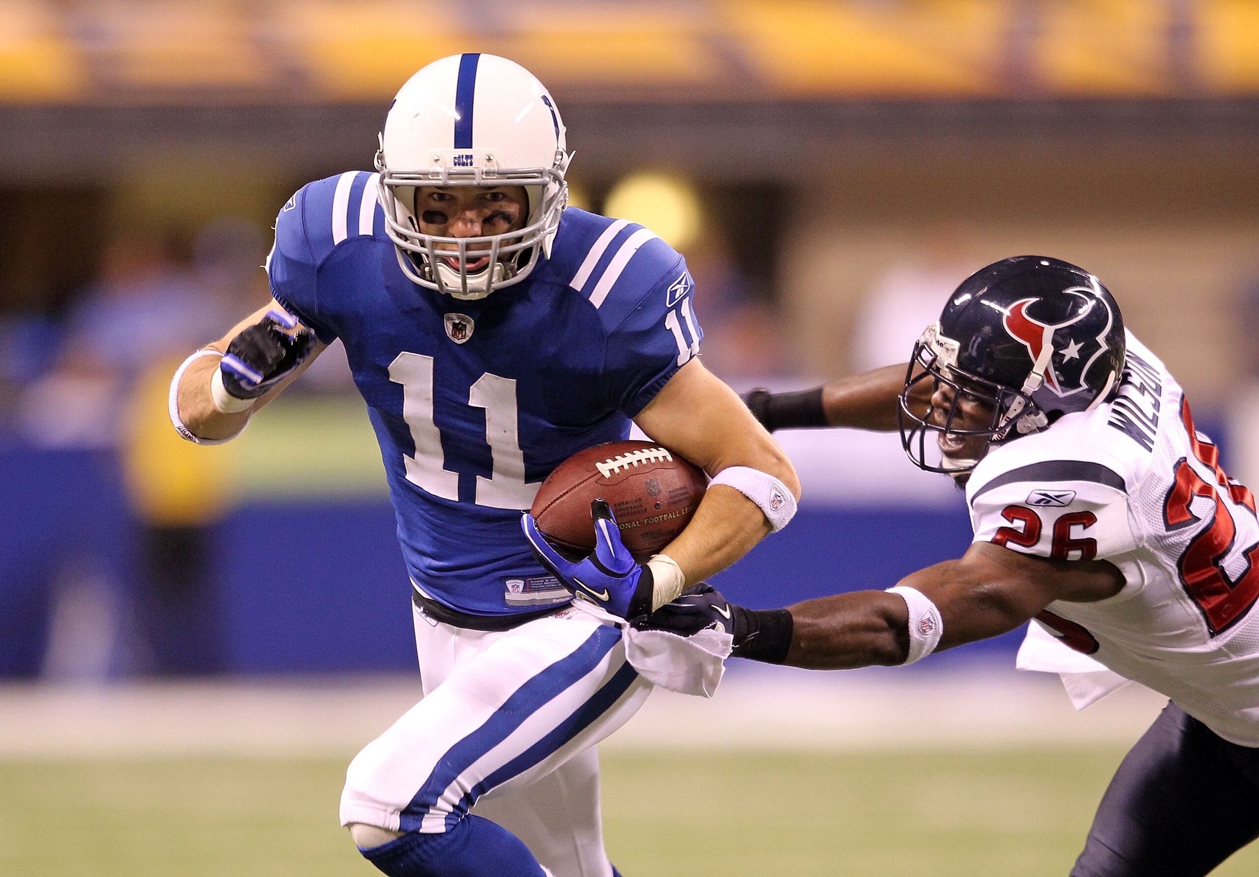INDIANAPOLIS - NOVEMBER 01: Anthony Gonzalez #11 of Indianapolis Colts runs with the ball while defended by Eugene Wilson #26 of the Houston Texans during the NFL game at Lucas Oil Stadium on November 1, 2010 in Indianapolis, Indiana. (Photo by Andy Lyon INDIANAPOLIS - NOVEMBER 01: Anthony Gonzalez #11 of Indianapolis Colts runs with the ball while defended by Eugene Wilson #26 of the Houston Texans during the NFL game at Lucas Oil Stadium on November 1, 2010 in Indianapolis, Indiana. (Photo by Andy Lyon