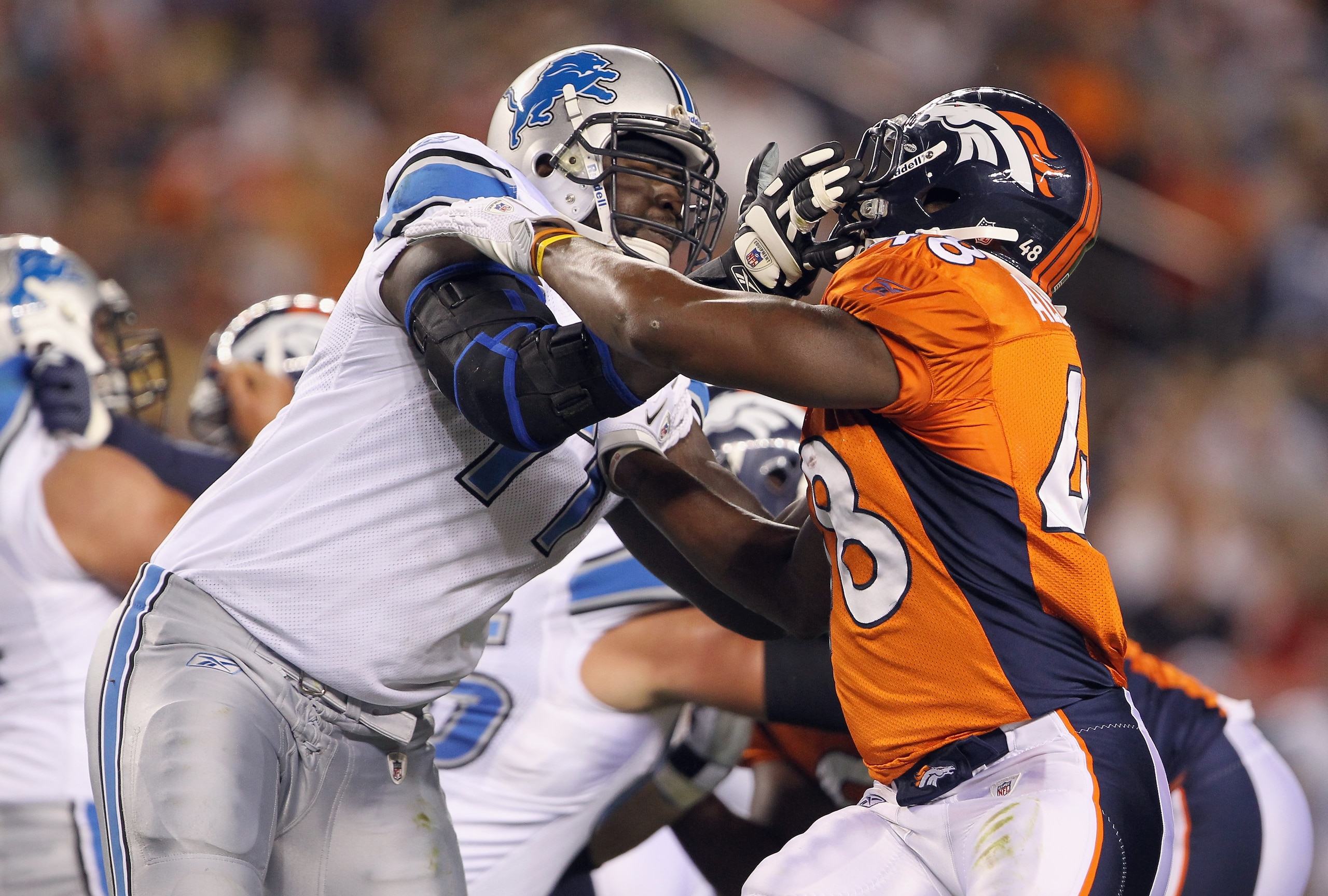 DENVER - AUGUST 21: Offensive tackle Gosder Cherilus #77 of the Detroit Lions blocks the rush of Kevin Alexander #48 of the Denver Broncos during preseason NFL action at INVESCO Field at Mile High on August 21, 2010 in Denver, Colorado. The Lions defeate DENVER - AUGUST 21: Offensive tackle Gosder Cherilus #77 of the Detroit Lions blocks the rush of Kevin Alexander #48 of the Denver Broncos during preseason NFL action at INVESCO Field at Mile High on August 21, 2010 in Denver, Colorado. The Lions defeate