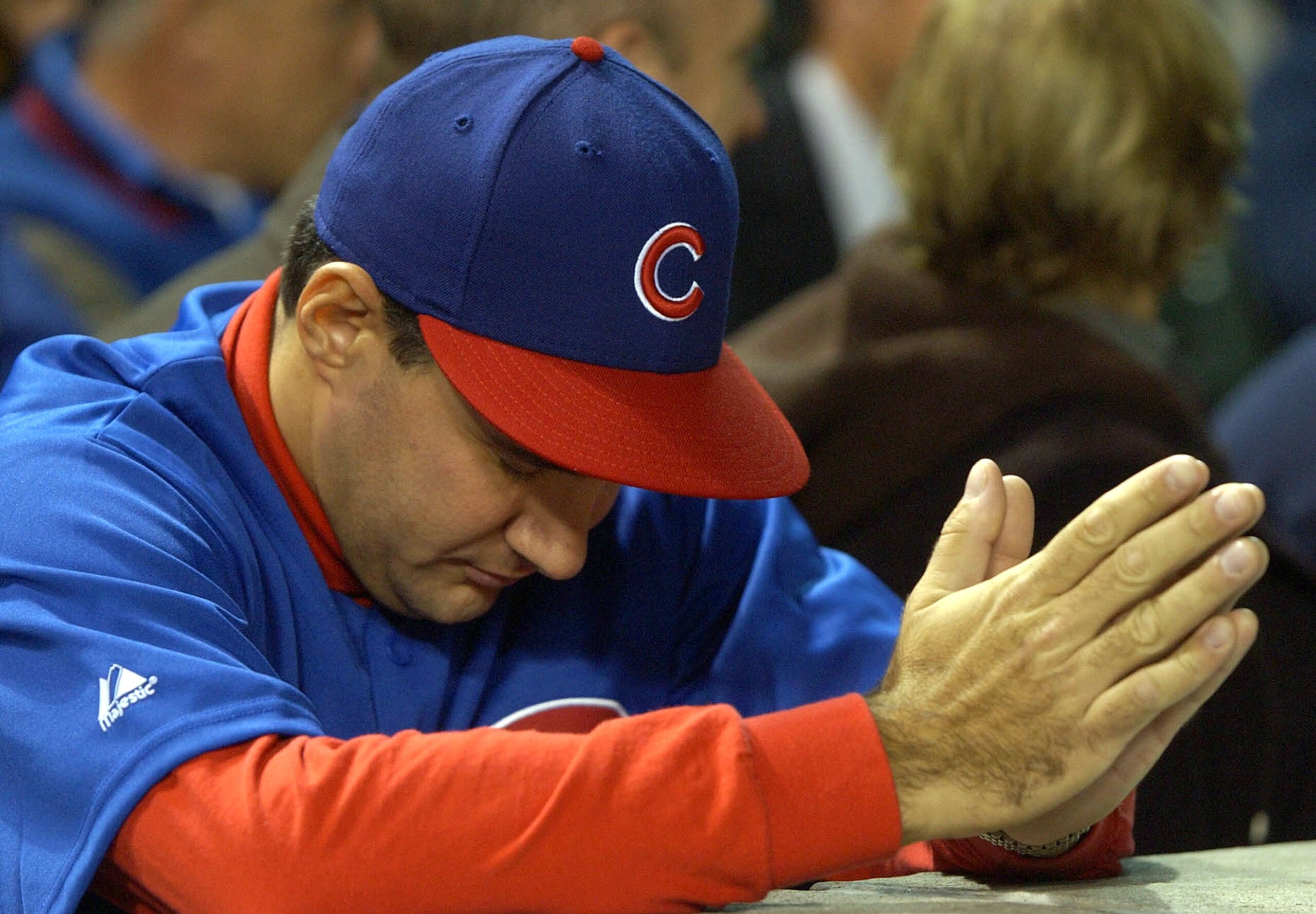 CHICAGO - OCTOBER 15:  An fan waits for the final outs between the Florida Marlins and the Chicago Cubs during game seven of the National League Championship Series October 15, 2003 at Wrigley Field in Chicago, Illinois. The marlins defeated the Cubs 9-6.