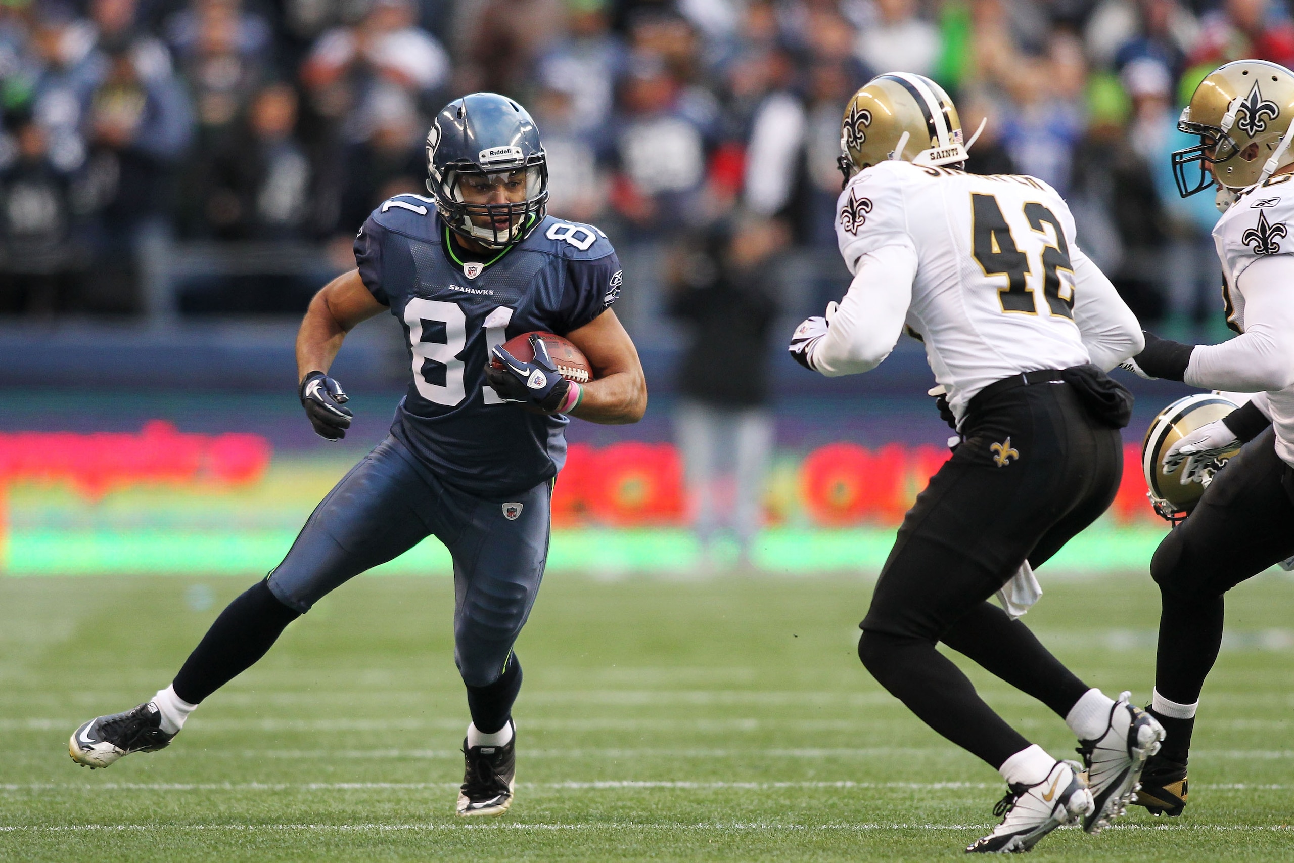 SEATTLE, WA - JANUARY 08: Golden Tate #81 of the Seattle Seahawks runs down field against Darren Sharper #42 of the New Orleans Saints during the 2011 NFC wild-card playoff game at Qwest Field on January 8, 2011 in Seattle, Washington. (Photo by Jonatha SEATTLE, WA - JANUARY 08: Golden Tate #81 of the Seattle Seahawks runs down field against Darren Sharper #42 of the New Orleans Saints during the 2011 NFC wild-card playoff game at Qwest Field on January 8, 2011 in Seattle, Washington. (Photo by Jonatha