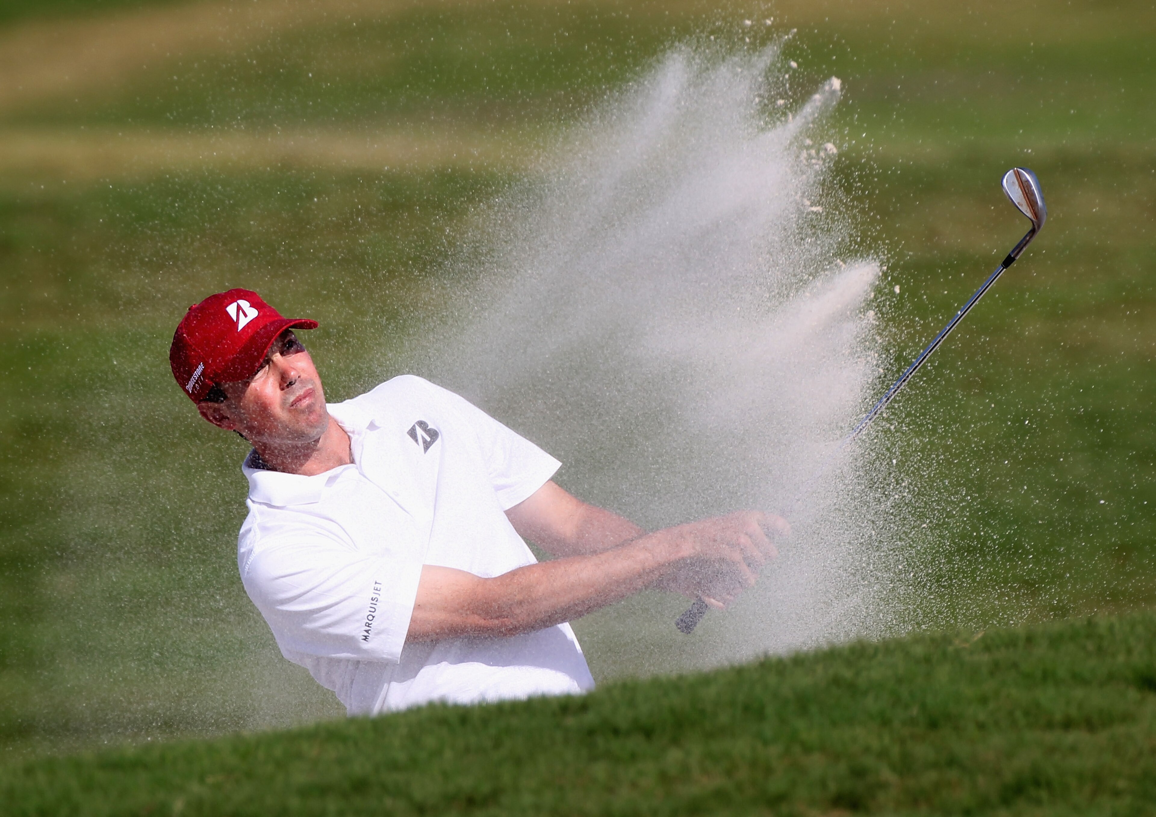 DORAL, FL - MARCH 12:  Matt Kuchar hits a bunker shot during the third round of the 2011 WGC- Cadillac Championship at the TPC Blue Monster at the Doral Golf Resort and Spa on March 12, 2011 in Doral, Florida.  (Photo by Sam Greenwood/Getty Images)