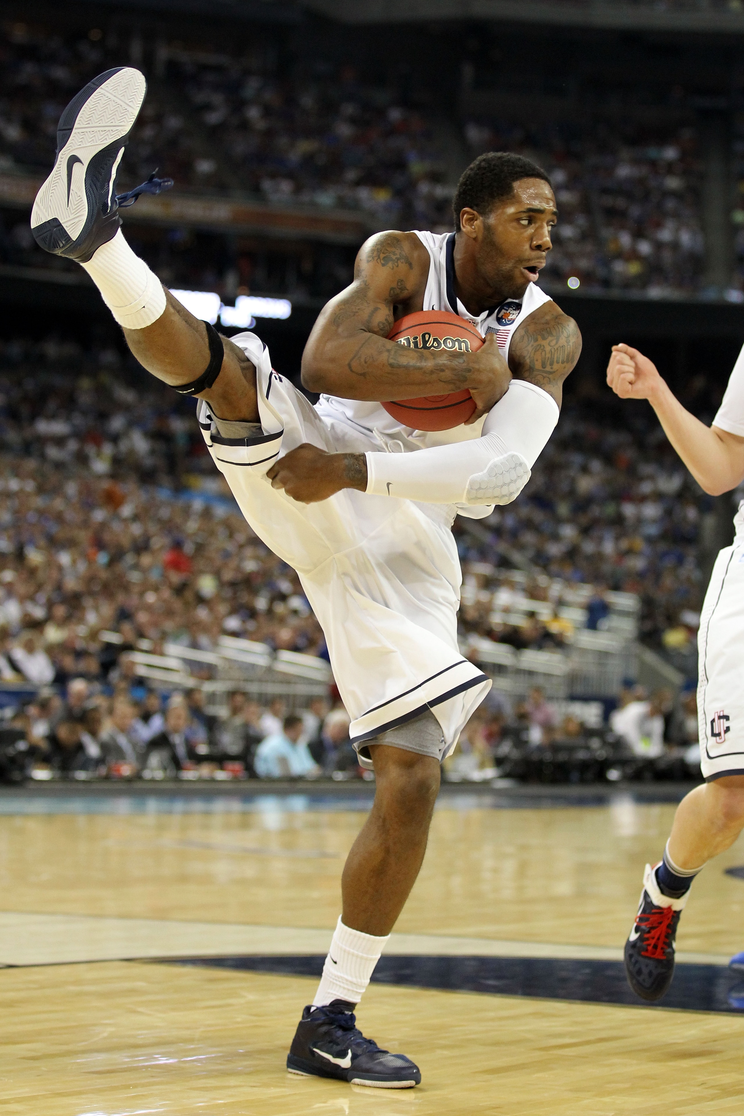 HOUSTON, TX - APRIL 02:  Alex Oriakhi #34 of the Connecticut Huskies pulls down a rebound against the Kentucky Wildcats during the National Semifinal game of the 2011 NCAA Division I Men's Basketball Championship at Reliant Stadium on April 2, 2011 in Hou