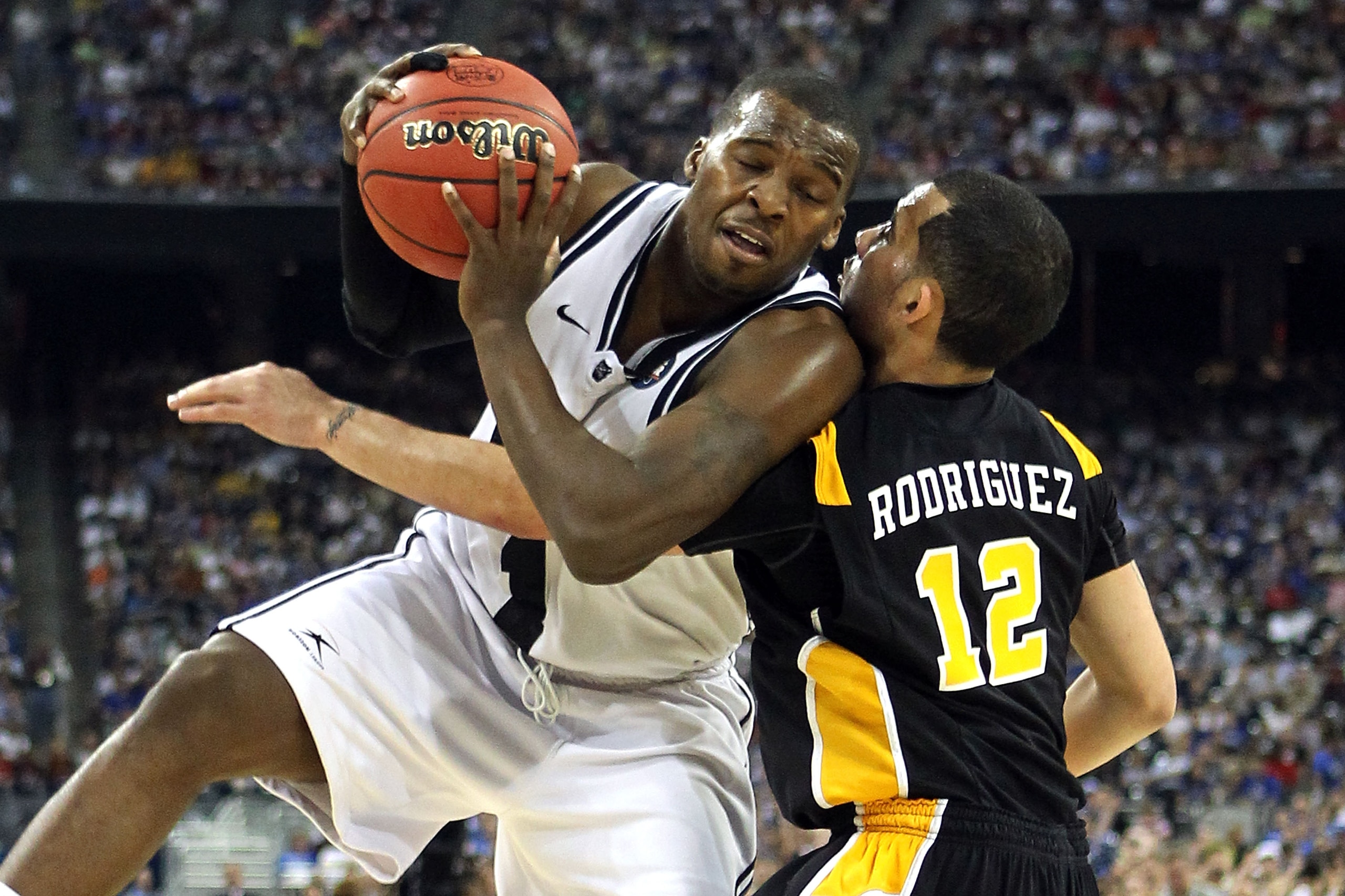 HOUSTON, TX - APRIL 02:  Shelvin Mack #1 of the Butler Bulldogs draws contact against Joey Rodriguez #12 of the Virginia Commonwealth Rams during the National Semifinal game of the 2011 NCAA Division I Men's Basketball Championship at Reliant Stadium on A