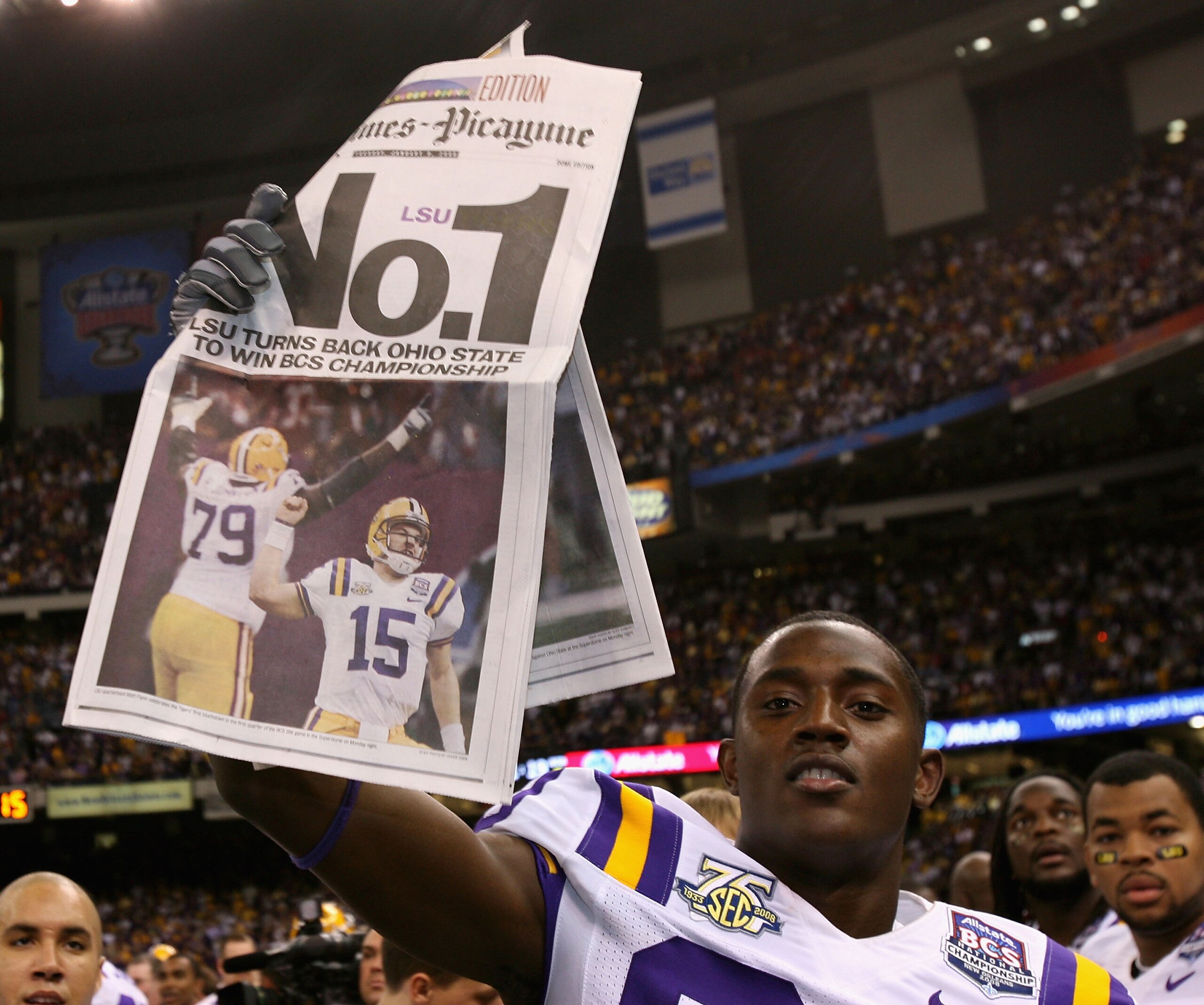 NEW ORLEANS - JANUARY 07:  Terrance Toliver #80 of the Louisiana State University Tigers holds up a newspaper in celebration after defeating the Ohio State Buckeyes 38-24 in the AllState BCS National Championship on January 7, 2008 at the Louisiana Superd