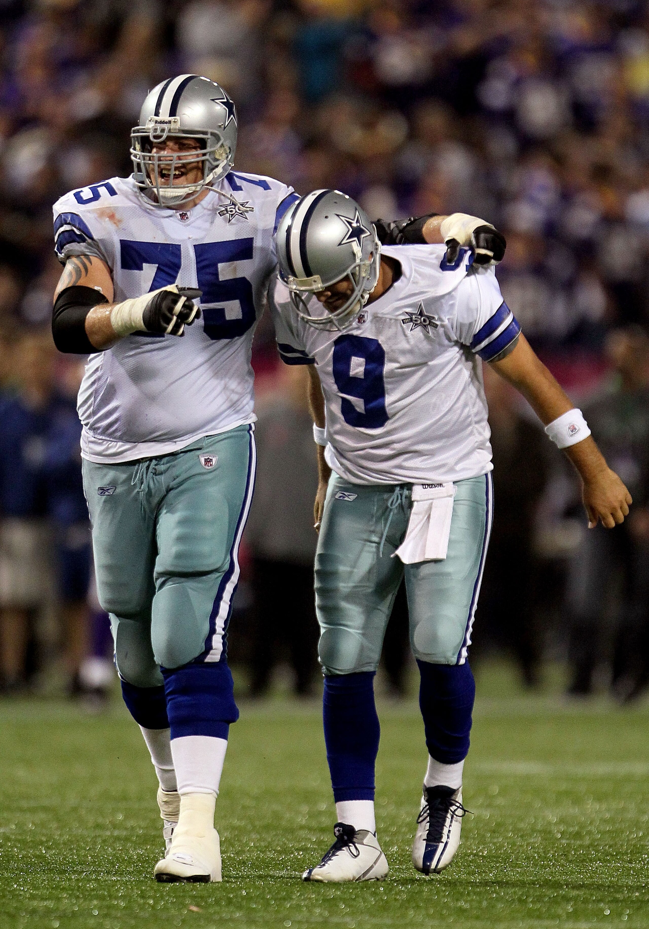 MINNEAPOLIS - OCTOBER 17:  Marc Colombo #75 and Tony Romo #9 of the Dallas Cowboys celebrate during the game against the Minnesota Vikings at Mall of America Field on October 17, 2010 in Minneapolis, Minnesota.  (Photo by Jeff Gross/Getty Images)