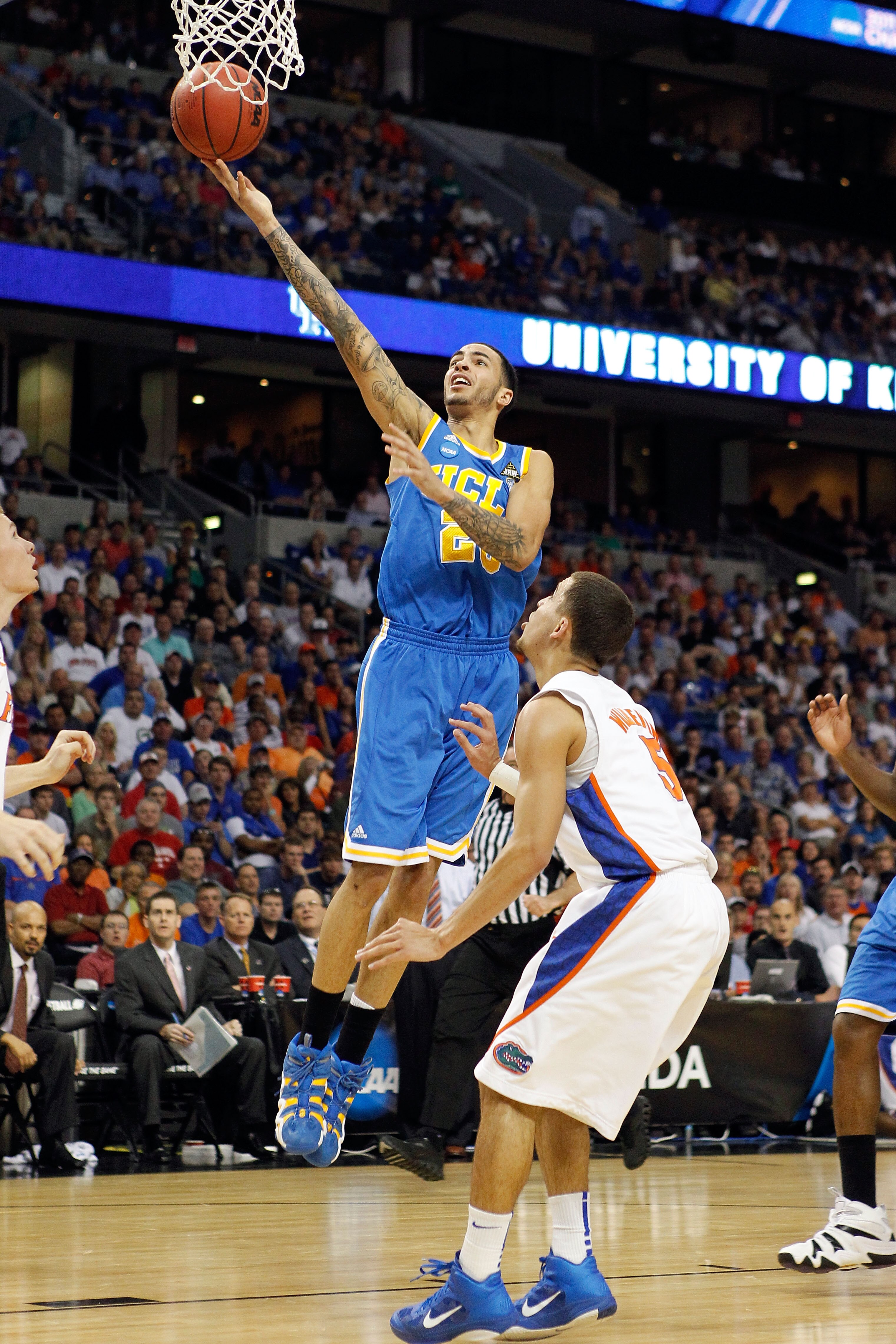 TAMPA, FL - MARCH 19:  Tyler Honeycutt #23 of the UCLA Bruins drives for a shot attempt against Scottie Wilbekin #5 of the Florida Gators during the third round of the 2011 NCAA men's basketball tournament at St. Pete Times Forum on March 19, 2011 in Tamp