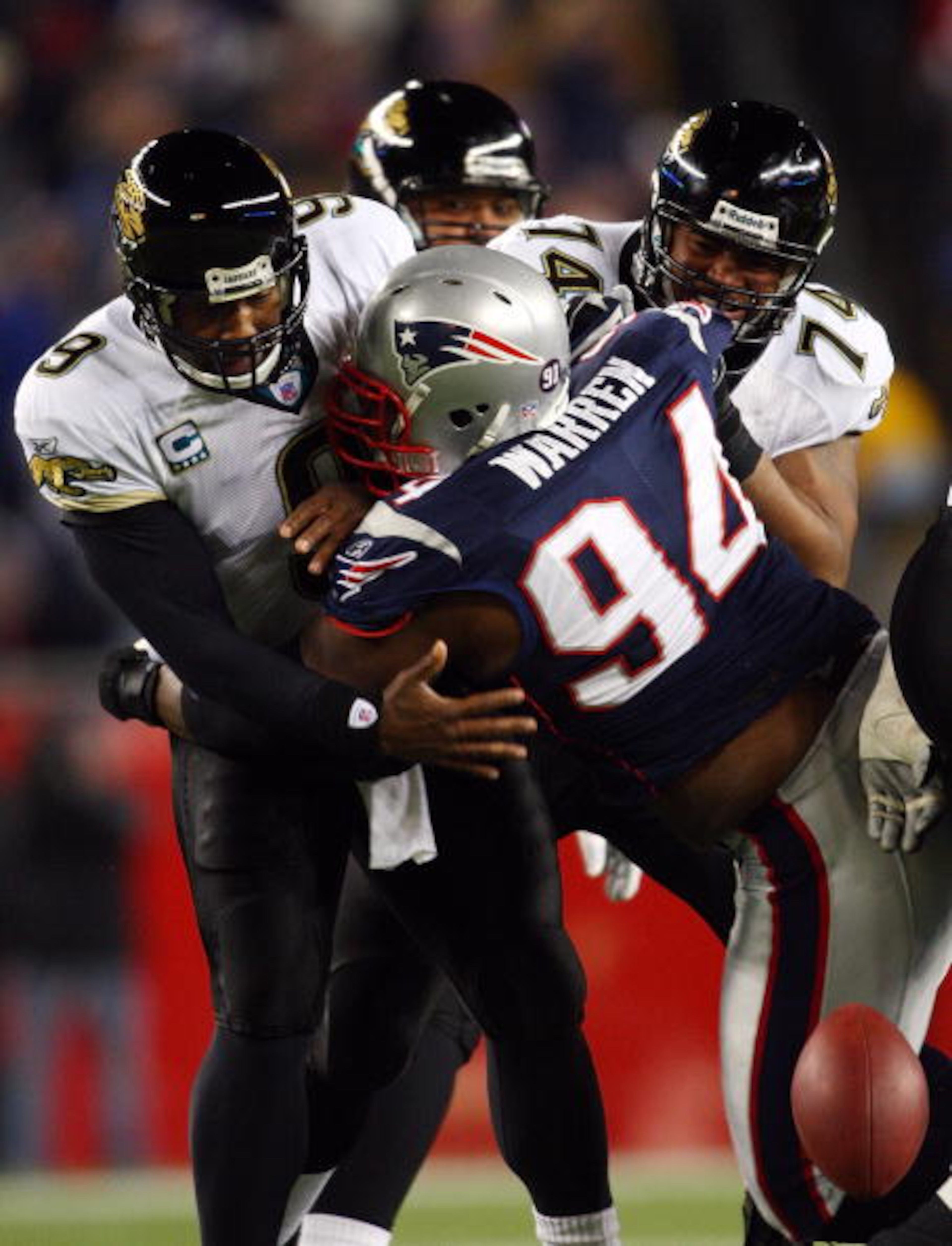 FOXBOROUGH, MA - JANUARY 12:  Ty Warren #94 of the New England Patriots causes David Garrard #9 of the Jacksonville Jaguars to fumble during the AFC Divisional playoff game at Gillette Stadium game on January 12, 2008 in Foxboro, Massachusetts.  (Photo by