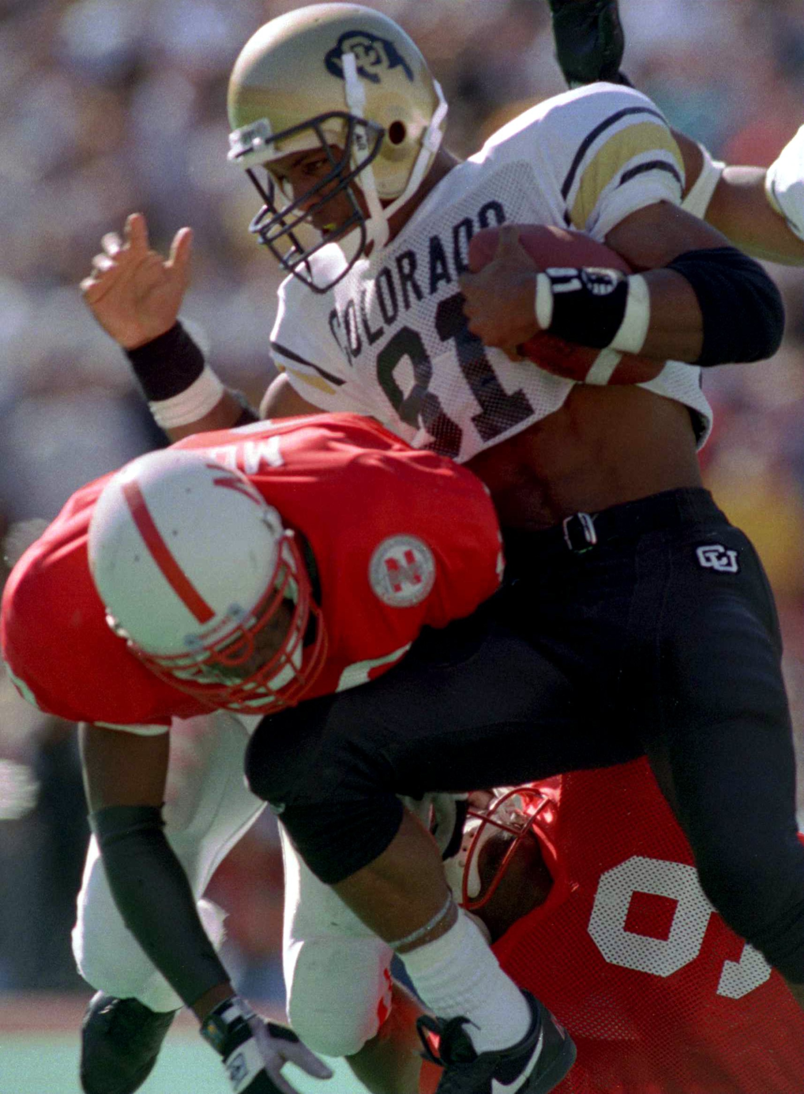 29 OCT 1994:  NEBRASKA''S KAREEM MOSS, LEFT  DRAGS DOWN COLORADO WIDE RECEIVER MICHAEL WESTBROOK DURING THIRD QUARTER ACTION OF THE CORNHUSKERS 24-7 VICTORY OVER THE BUFFALOES AT MEMORIAL STADIUM IN LINCOLN, NEBRASKA. Mandatory Credit: Todd Rosenberg/ALLS